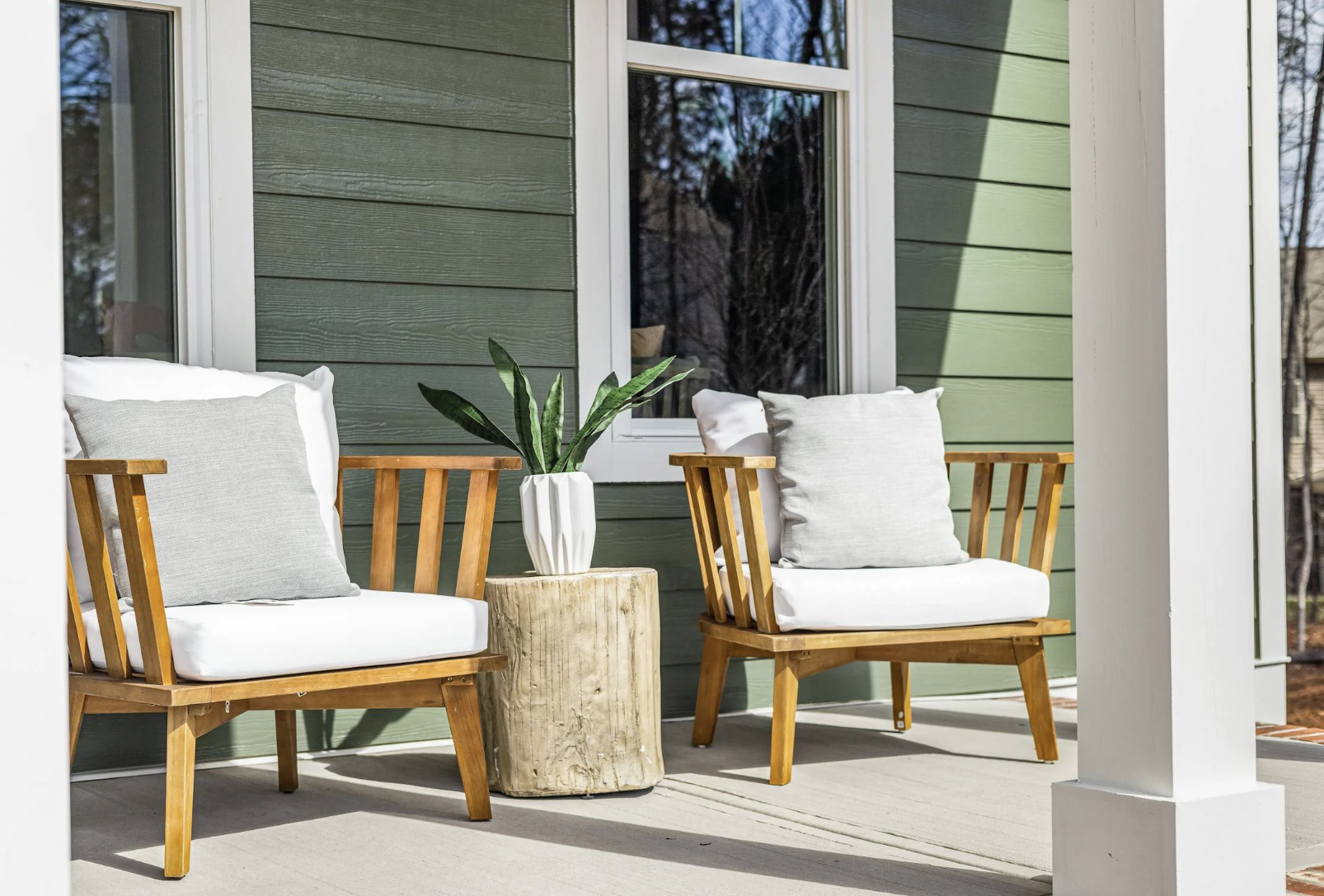 two chairs sitting on a front porch