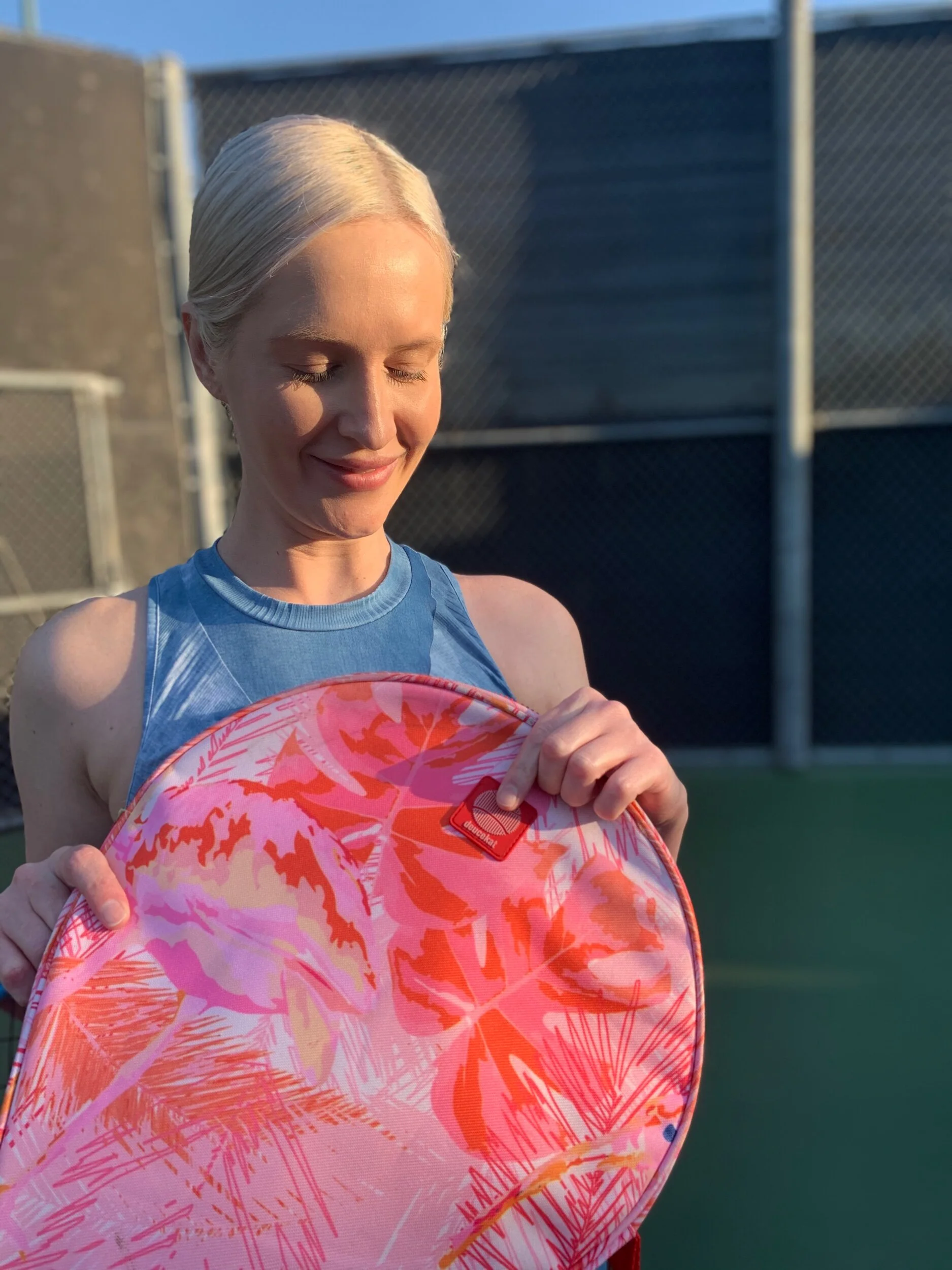 Woman with tropical print tennis bag