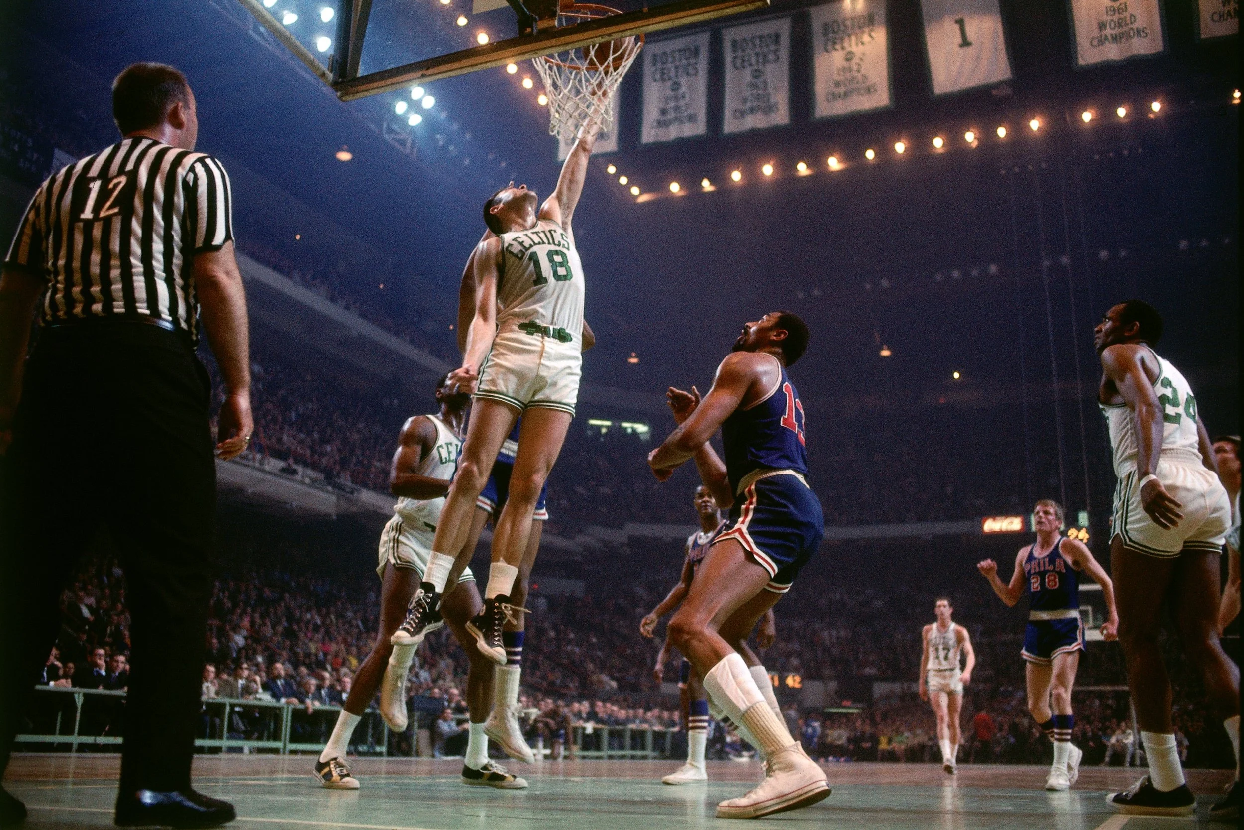 Howell cramming one and Wilt Chamberlain gets a front row seat.