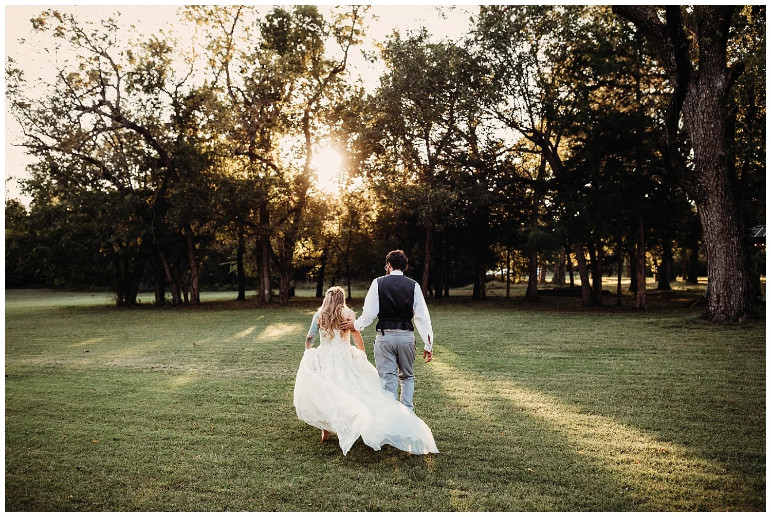 Bride and Groom walking in tress at Golden Hour on their wedding day.
