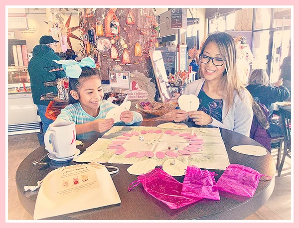 Scenes from a Prairie Fairies Game Day: Players exchange flora fashions and plant seeds in the garden in Prairie Fairies , while enjoying tea on location at a local treasure– All Chocolate Kitchen in Geneva, Illinois.