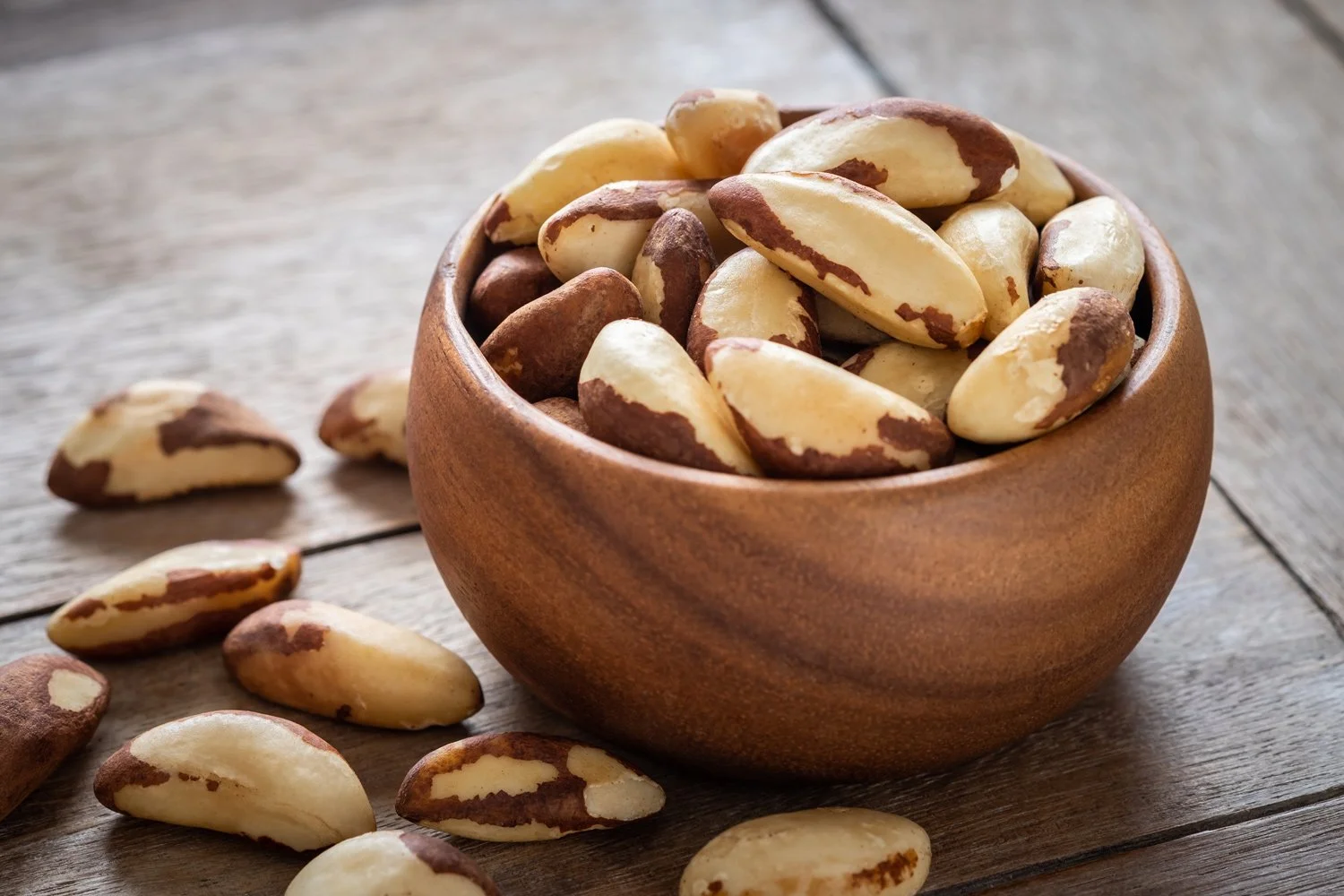 raw brazil nuts in wooden bowl