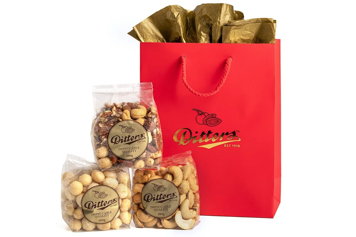 ditters gift bag filled with gawler place mix, salted macadamias and salted cashews in a red gift bag
