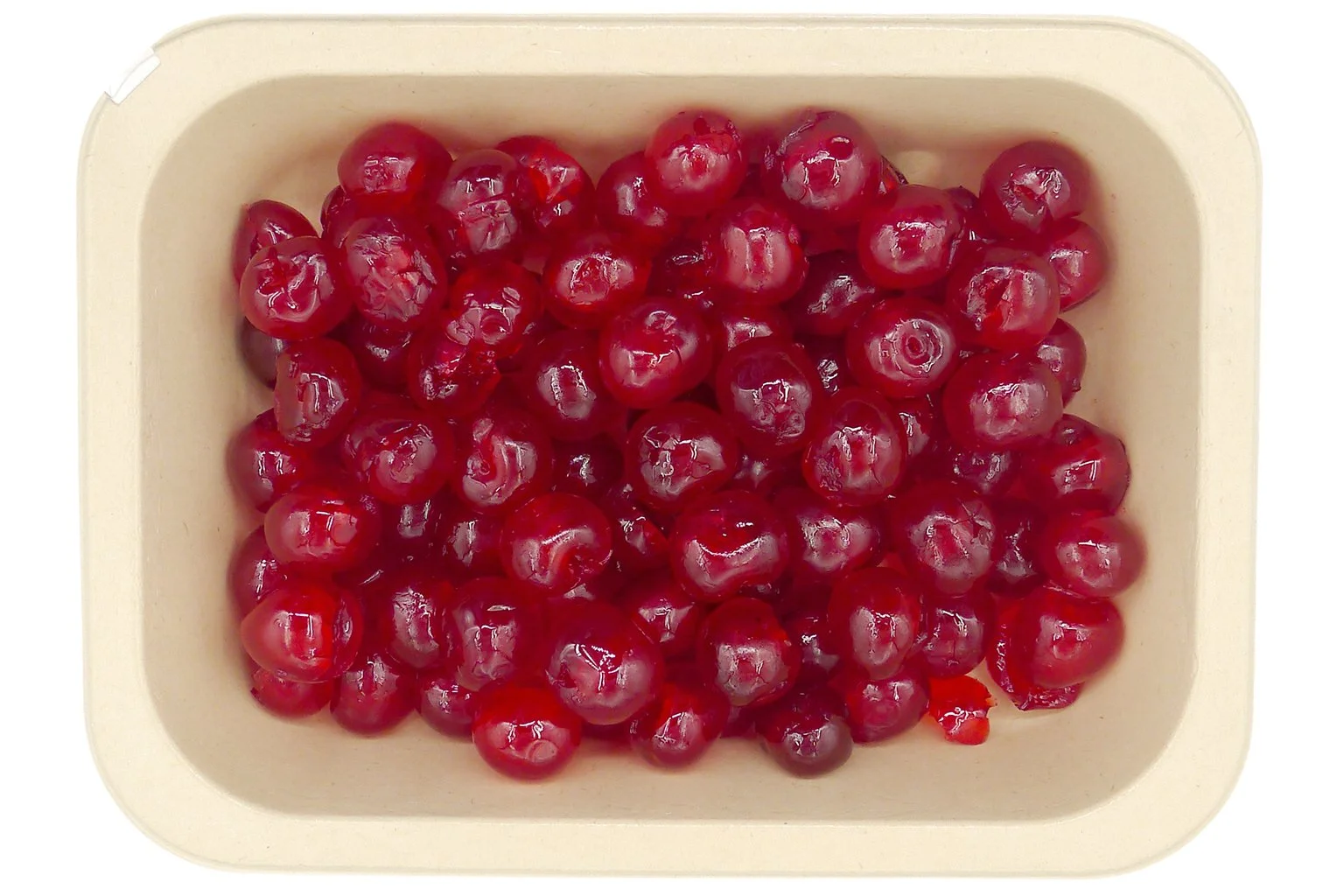 Premium red glacé cherries with a glossy finish arranged in a compostable tray.