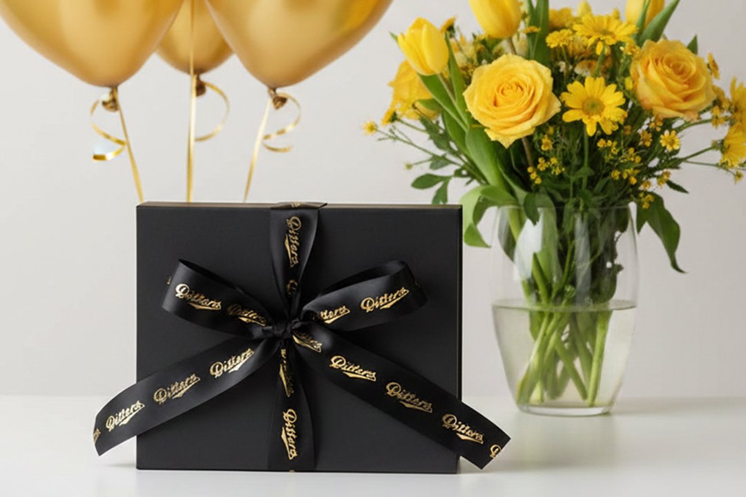 ditters black hamper with gold balloons and yellow flowers in the background