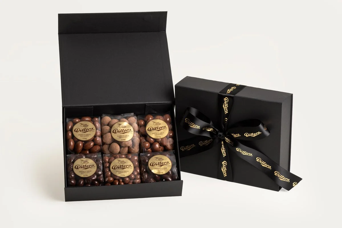 Ditters milk and dark chocolate hamper in black box with a big black and gold bow