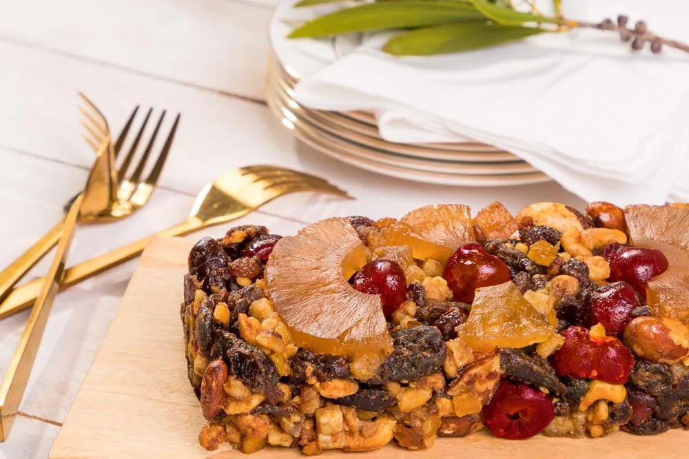 Ditters gourmet cake on wooden serving board with red bottlebrush decoration