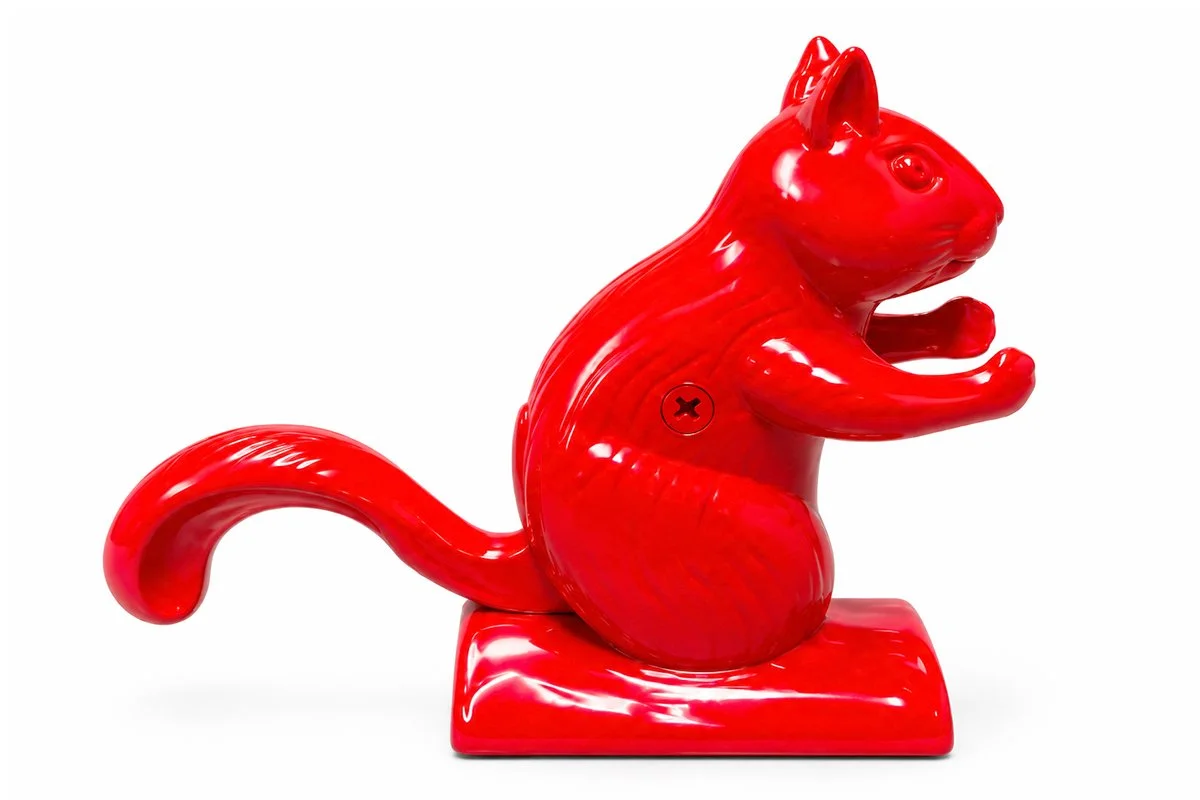 Side view of The Ditters Squirrel Nutcracker showing its cast metal body, tail lever and nut-cracking mechanism.