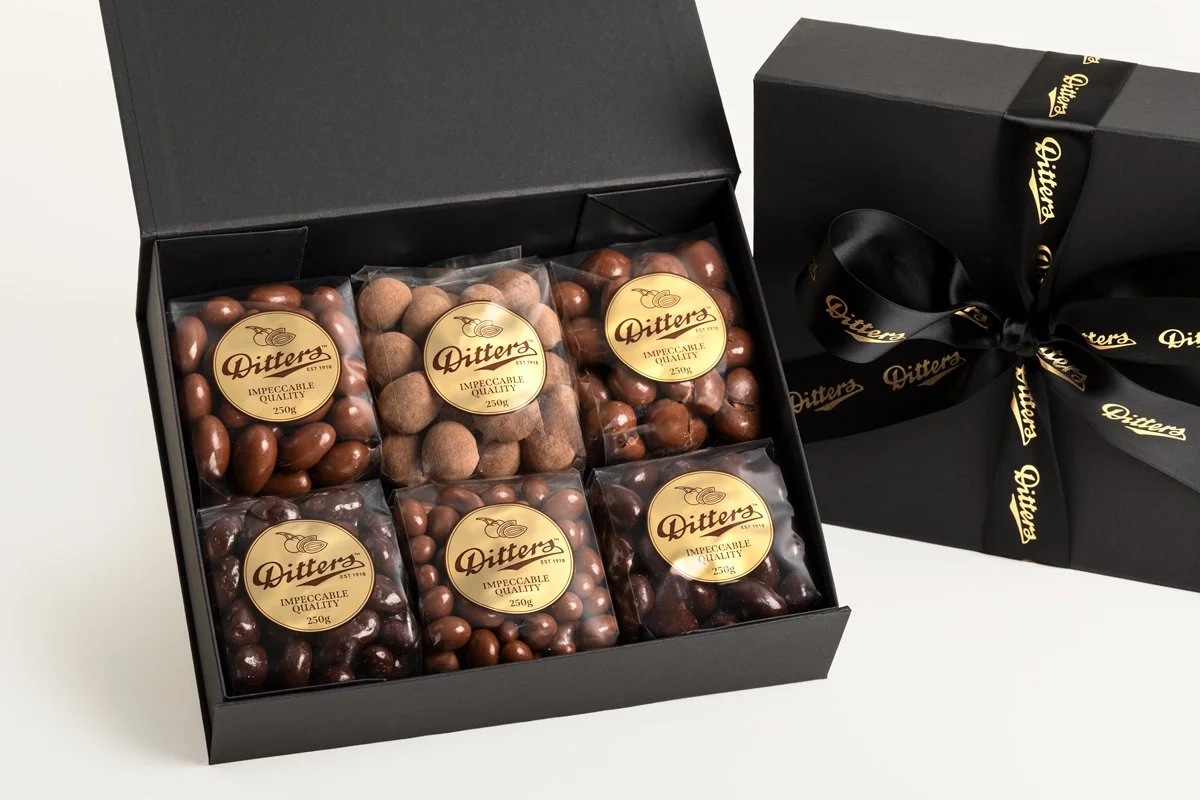Ditters milk and dark chocolate hamper in black box with a big black and gold bow