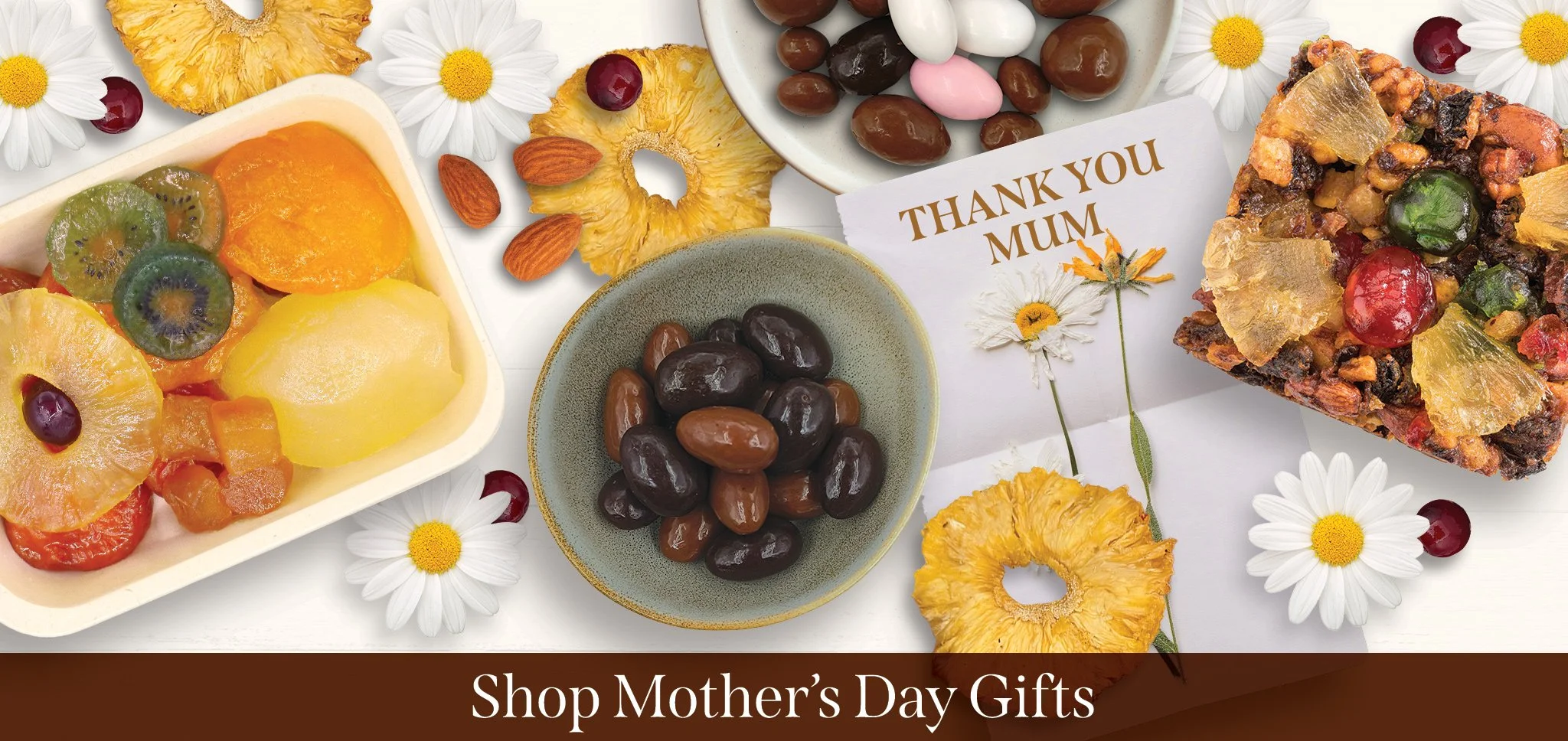 assorted glazed fruit, dried pineapple, dry roasted almonds, nutty fruit cake, and chocolate coated almonds next to card saying thank you mum
