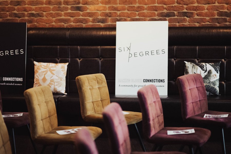 Sign saying six degrees and chair sets up ready for networking event