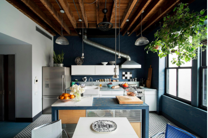 In the kitchen, Mr. Salasky exposed the ceiling joists and stripped the walls down to brick, which he painted a deep blue, and added a plywood-covered wall with windows
