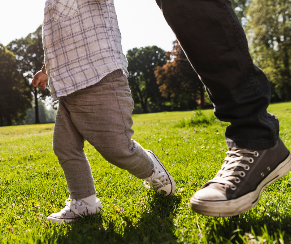 child and father walking