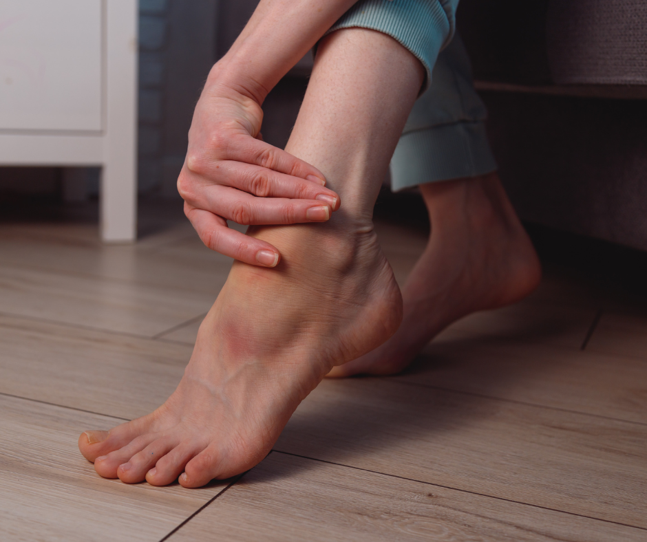 woman rubbing ankle