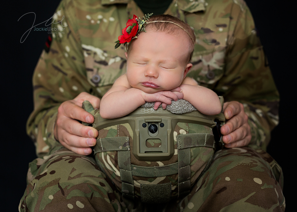 Baby in soldiers hat in daddy's hat