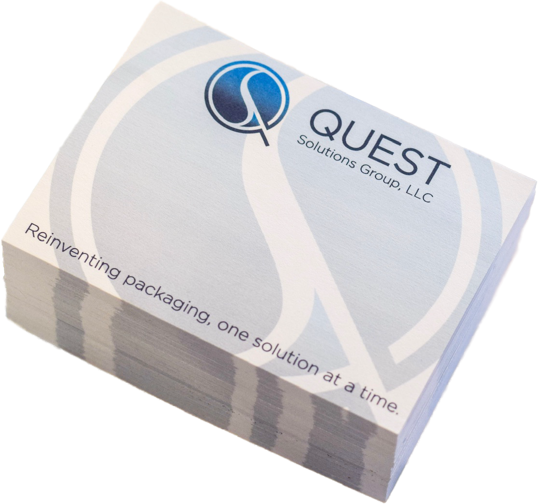 A stack of business cards with the logo and branding of QUEST Solutions Group, LLC, featuring the slogan 'Reinventing packaging, one solution at a time.'