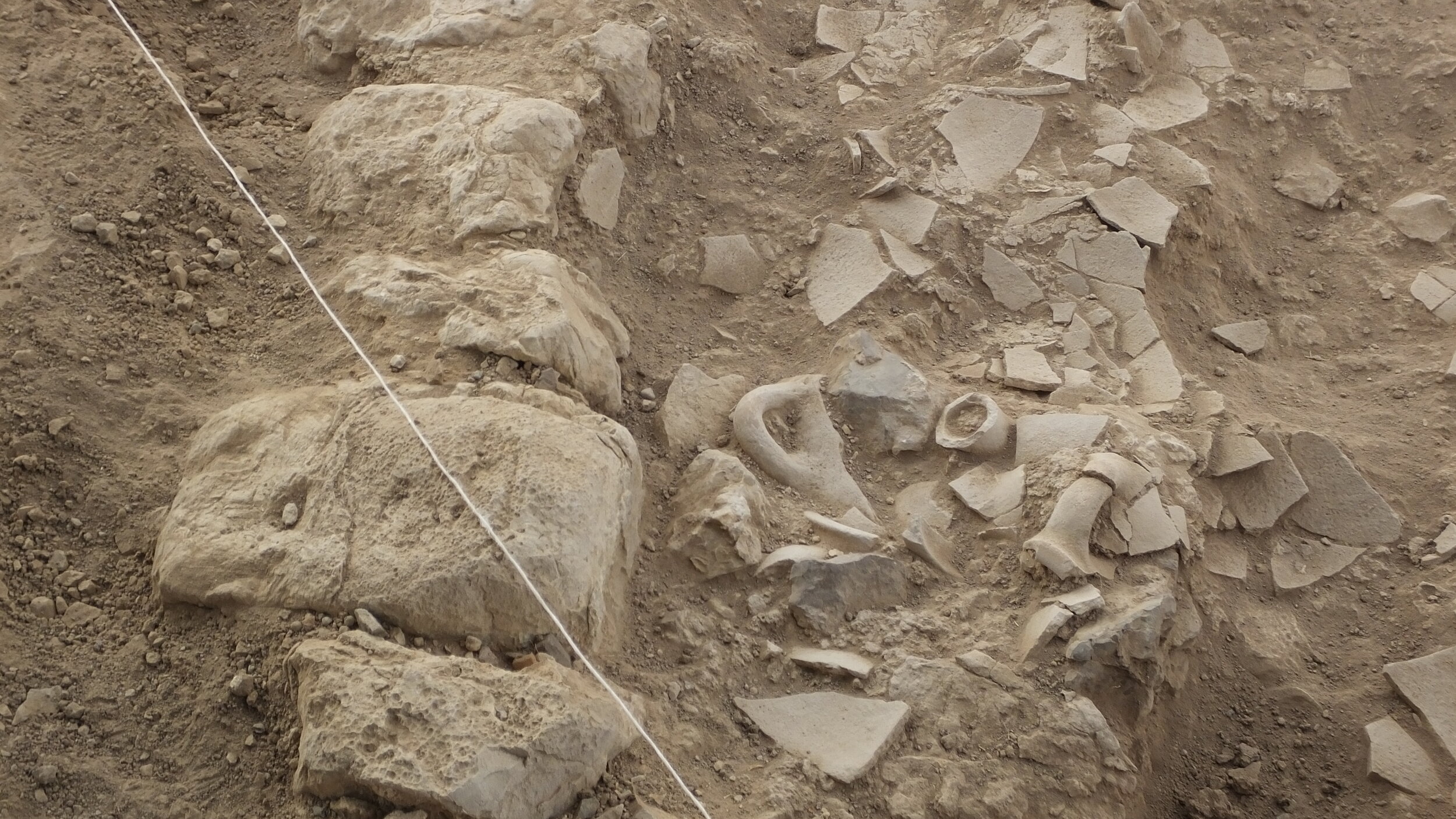 Crushed pottery abutting a wall at 'Auja el-Foqa.JPG