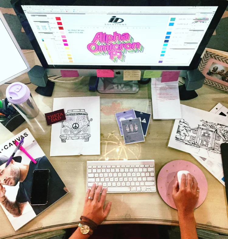 girl working on custom designs for t shirts on her computer