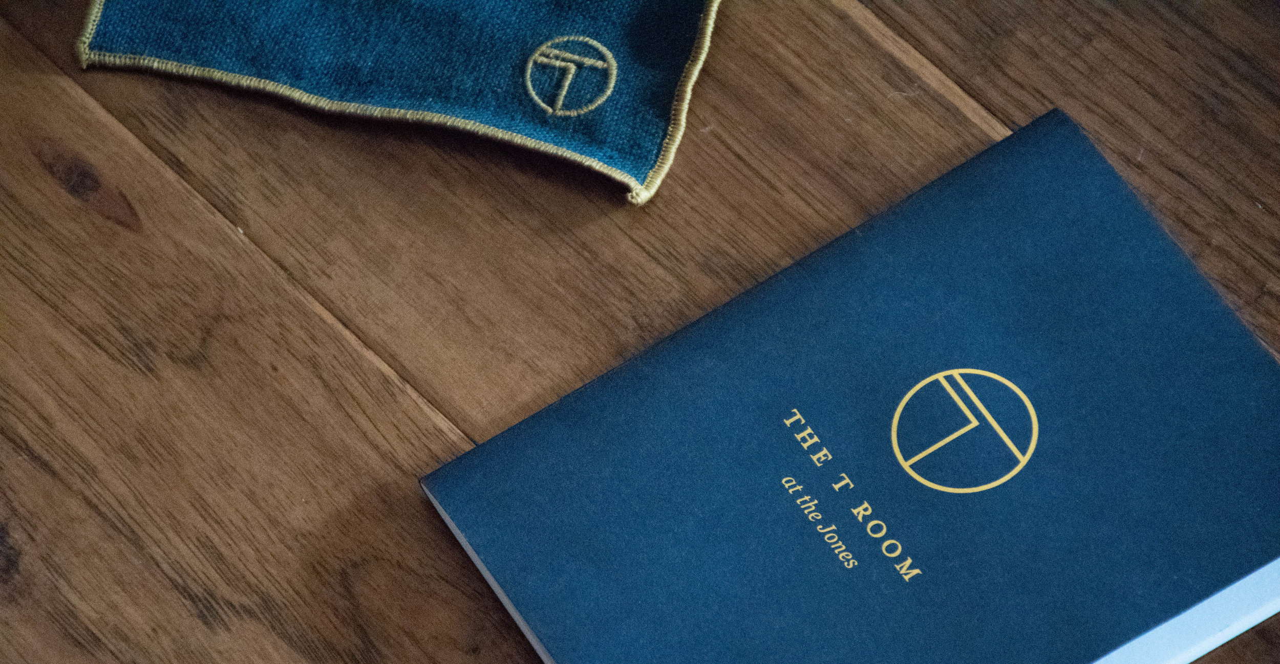  Details of the menu foiling and napkin embroidery. 
