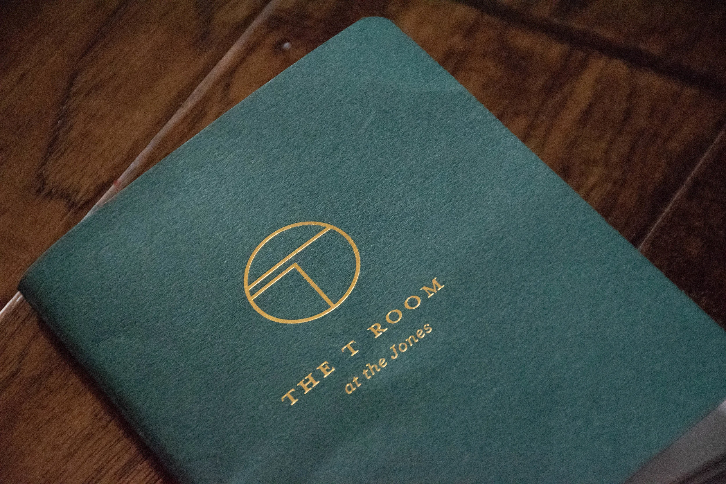  The T Room menu volume II cover. Created in a Mohawk Forest Green Vellum duplexed with white paper. 