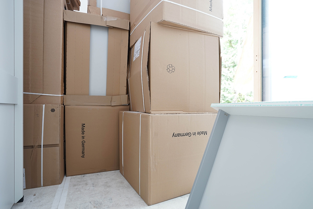 Delivered! Unloading LEICHT kitchen boxes on site Ames Lake residence.