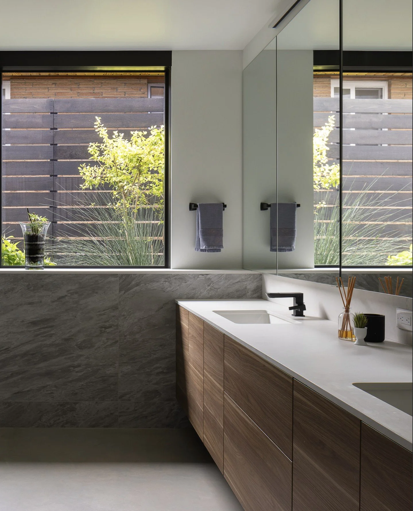 A lakeside sanctuary nestled in Greenlake, this Seattle home features stunning LEICHT cabinetry designs across the bathroom, kitchen and laundry room.⁠
⁠
Seamless wood veneer vanity cabinets add warmth and serenity to the bathrooms while floor-to-cei