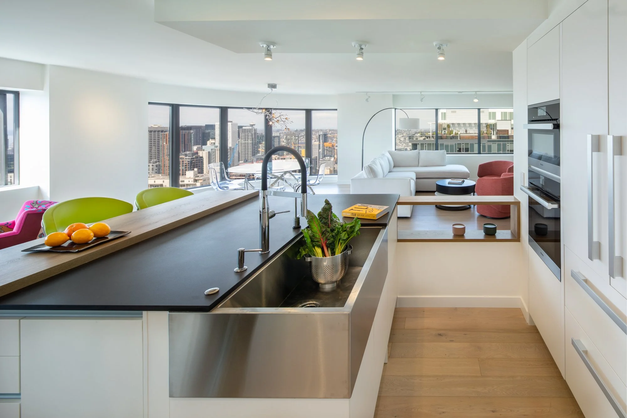 Large white kitchen with open views of Seattle skyline showcasing European design in the kitchen comparison debate.