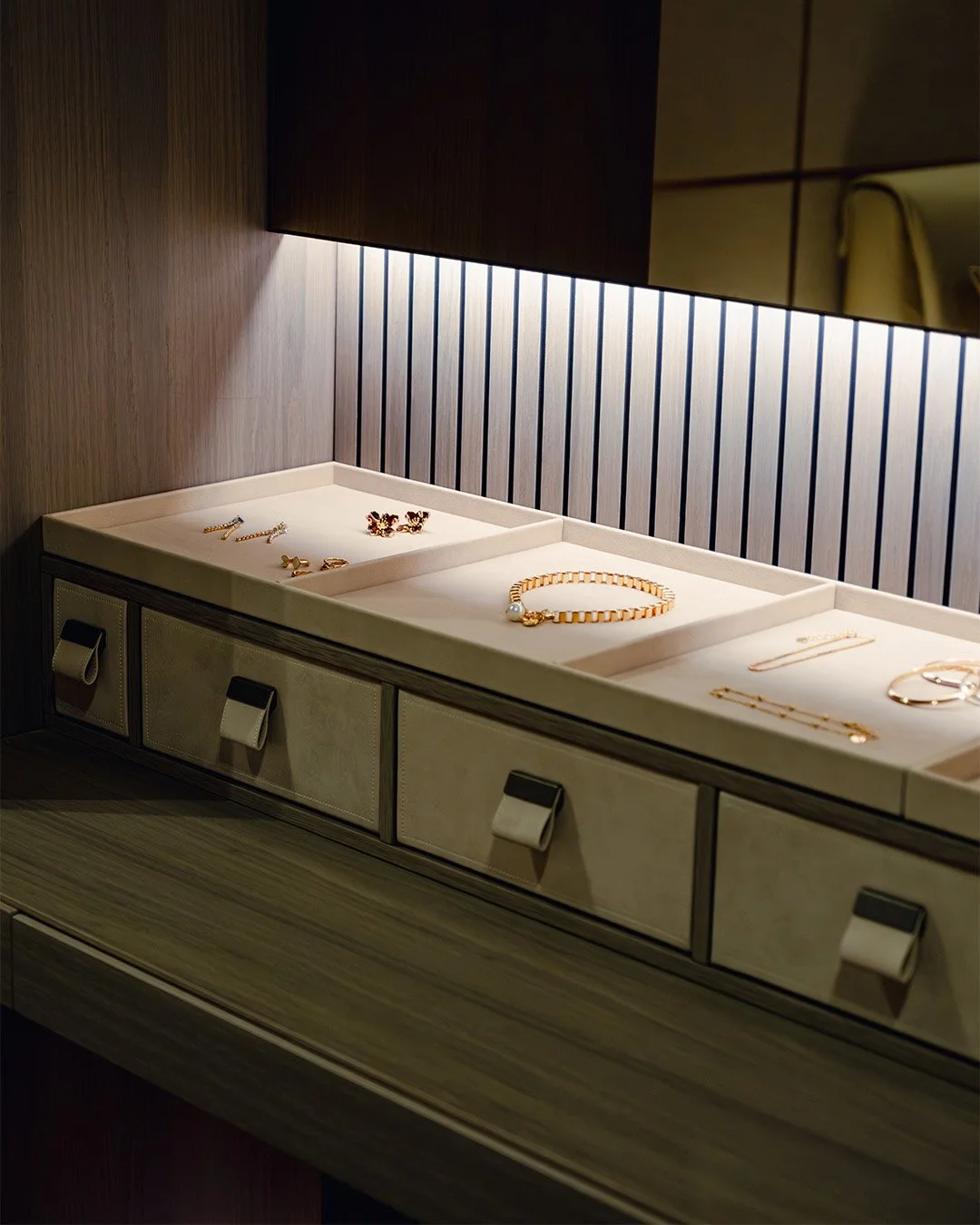 Lit jewellery drawer in a Misura Emme closet with LED strip lighting above suede-front drawers