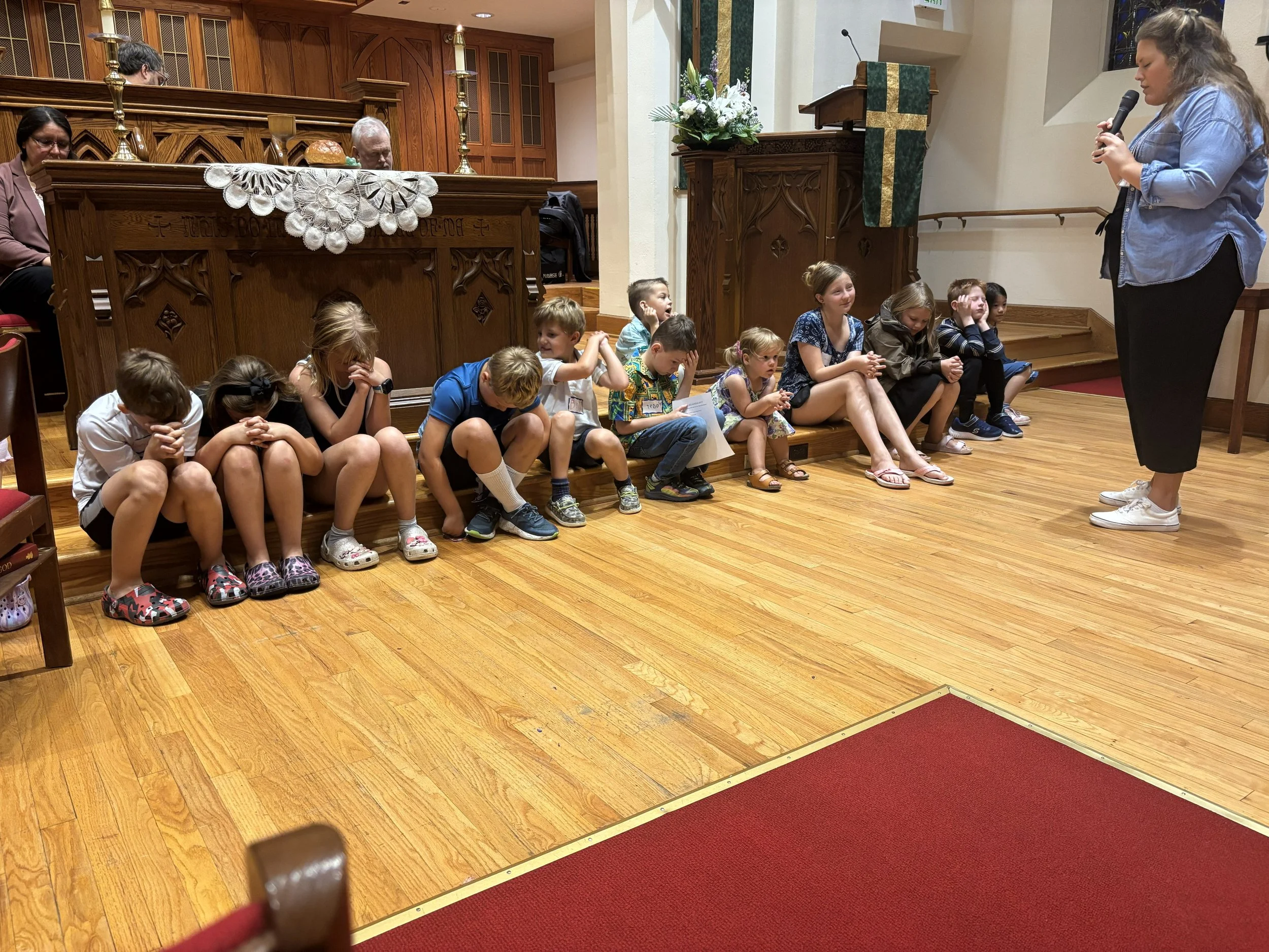Sarah praying with kids.jpeg