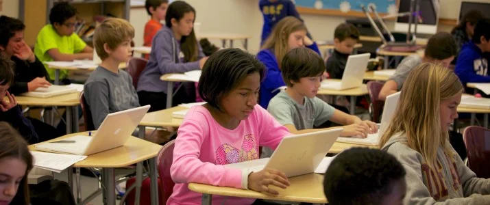 Thinkers_classroom_girl-in-pink-shirt-with-computer-715x300.jpg