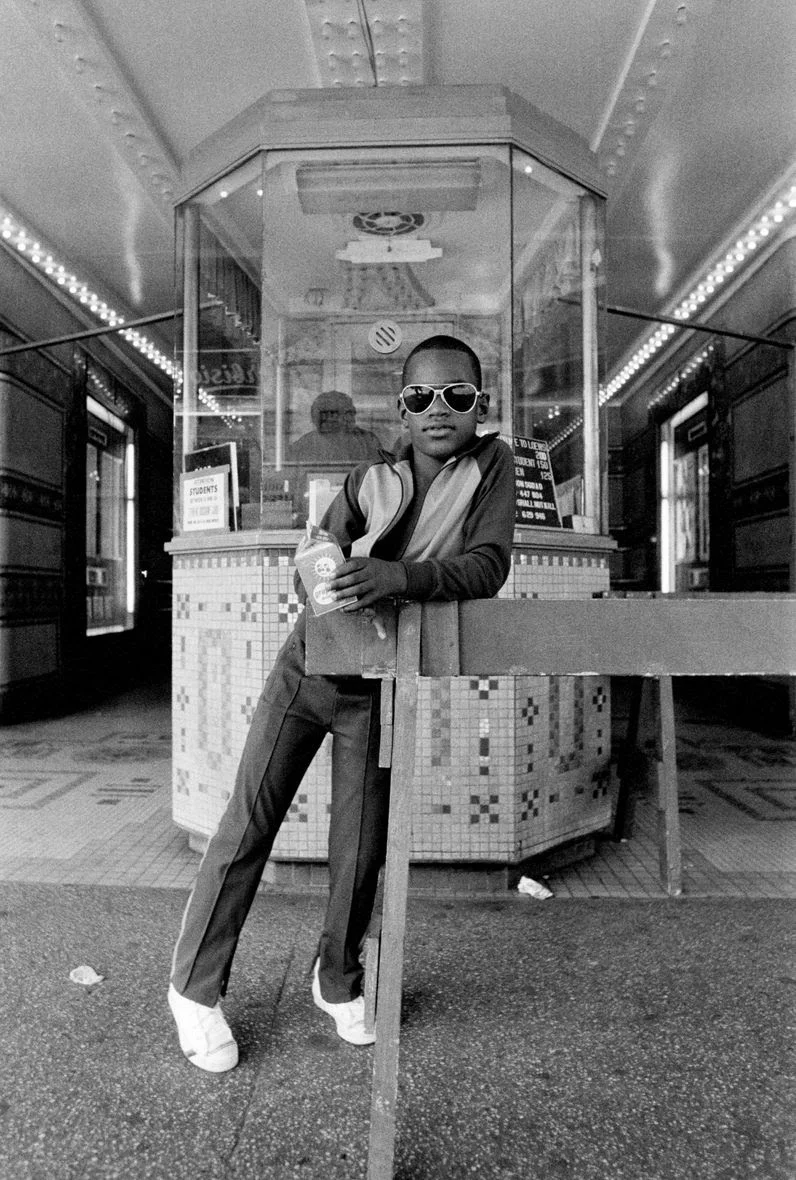 A Boy in front of the Loew's 125th Street Movie Theater , 1976 © Dawoud Bey / courtesy Stephen Daiter Gallery, Chicago, Stephen Bulger Gallery, Toronto