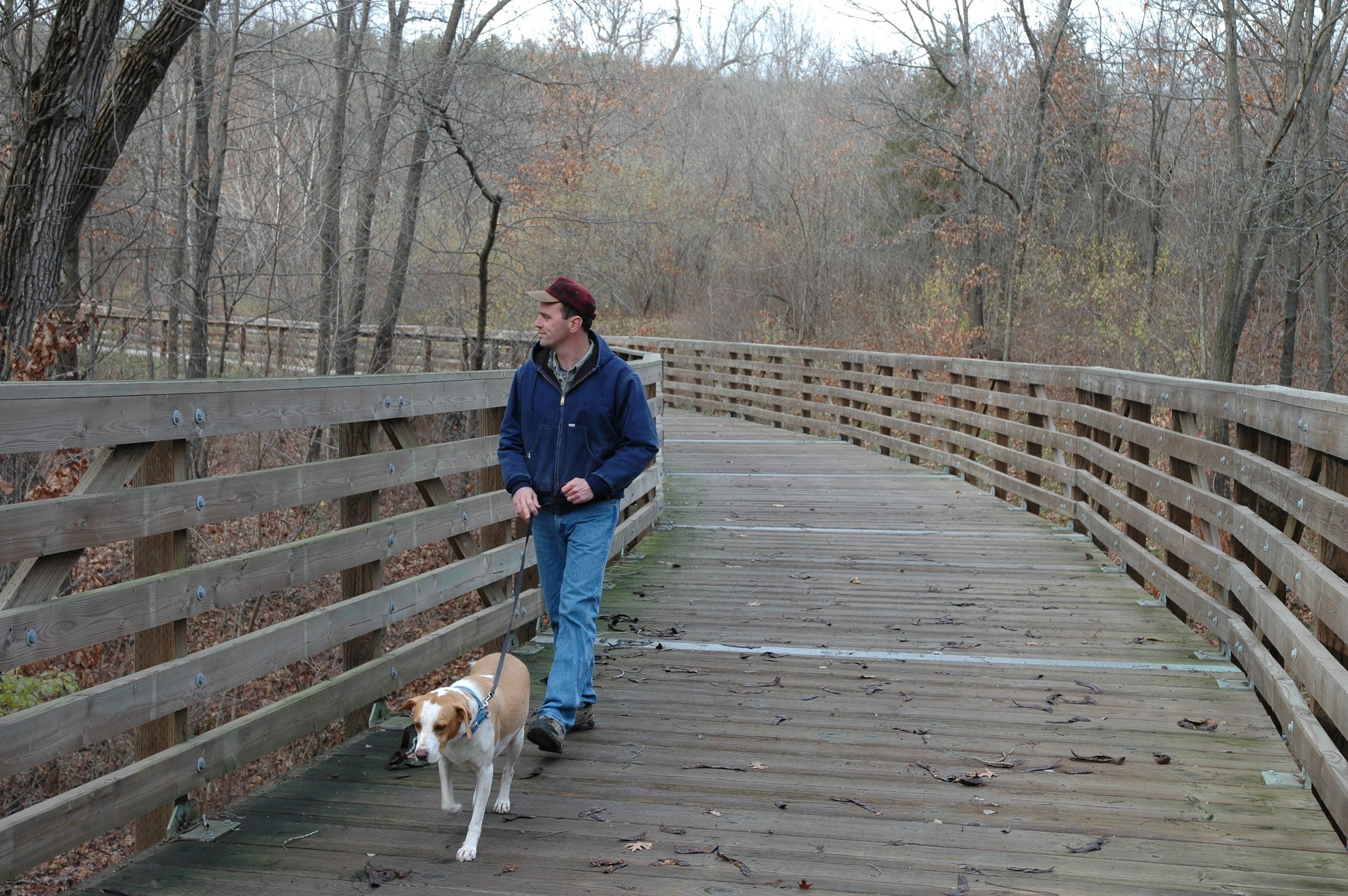 man with dog on trail bridge.jpg