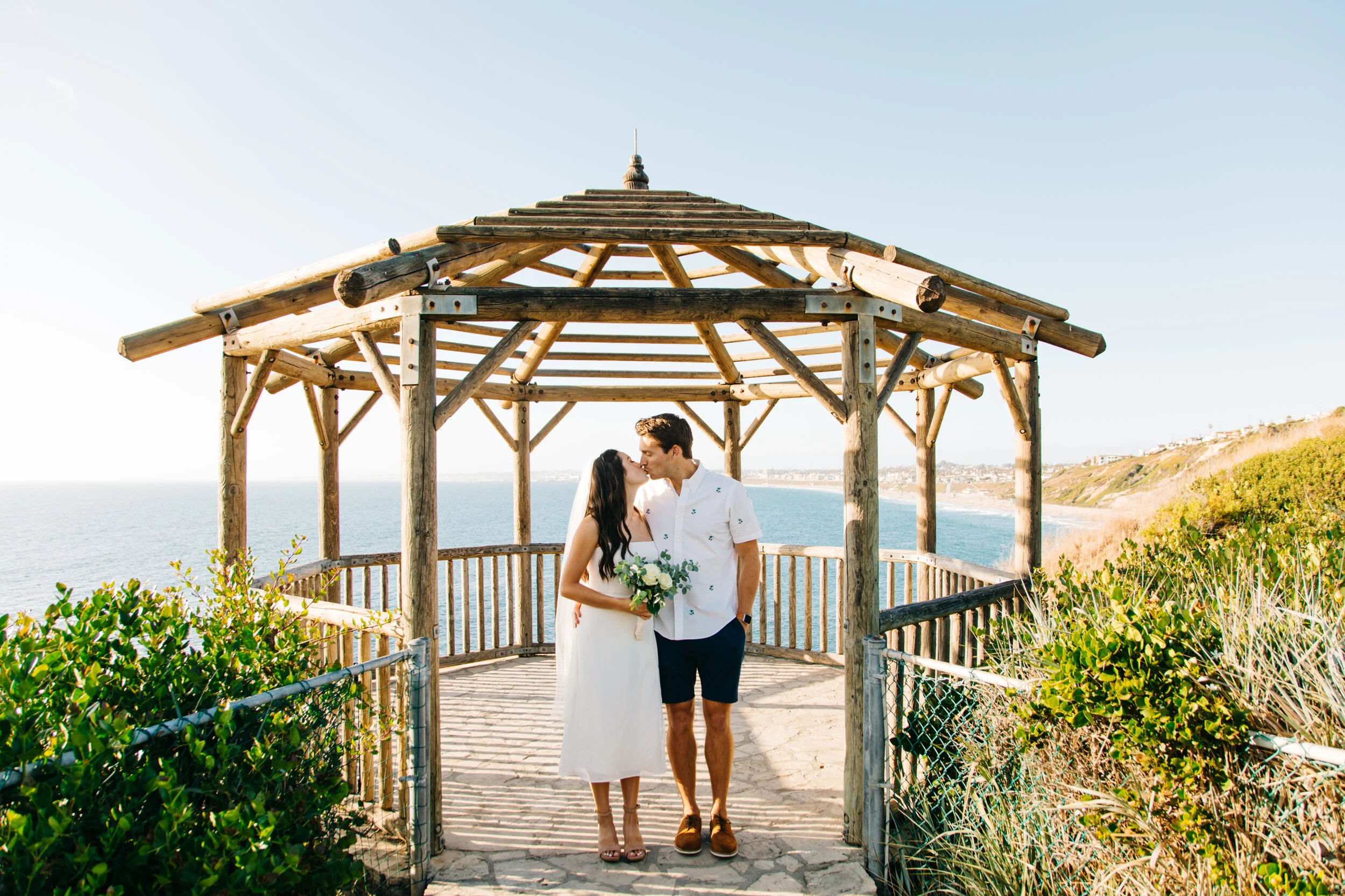 Couple getting married under a gazebo in Palos Verdes during a mobile wedding ceremony by 1 Hour Marriage.