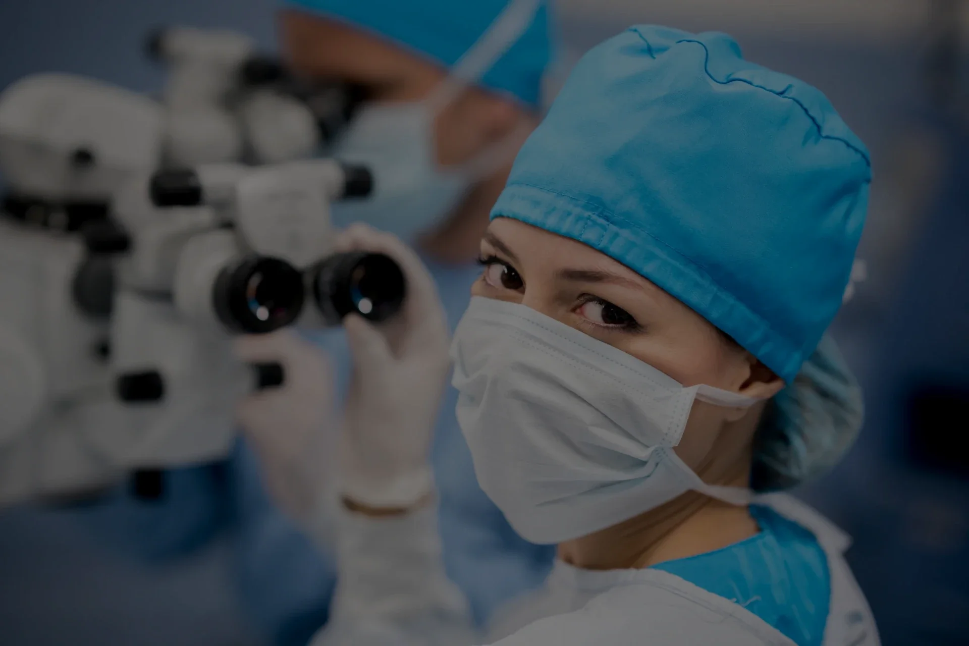ophthalmologist working and smiling at the camera.webp