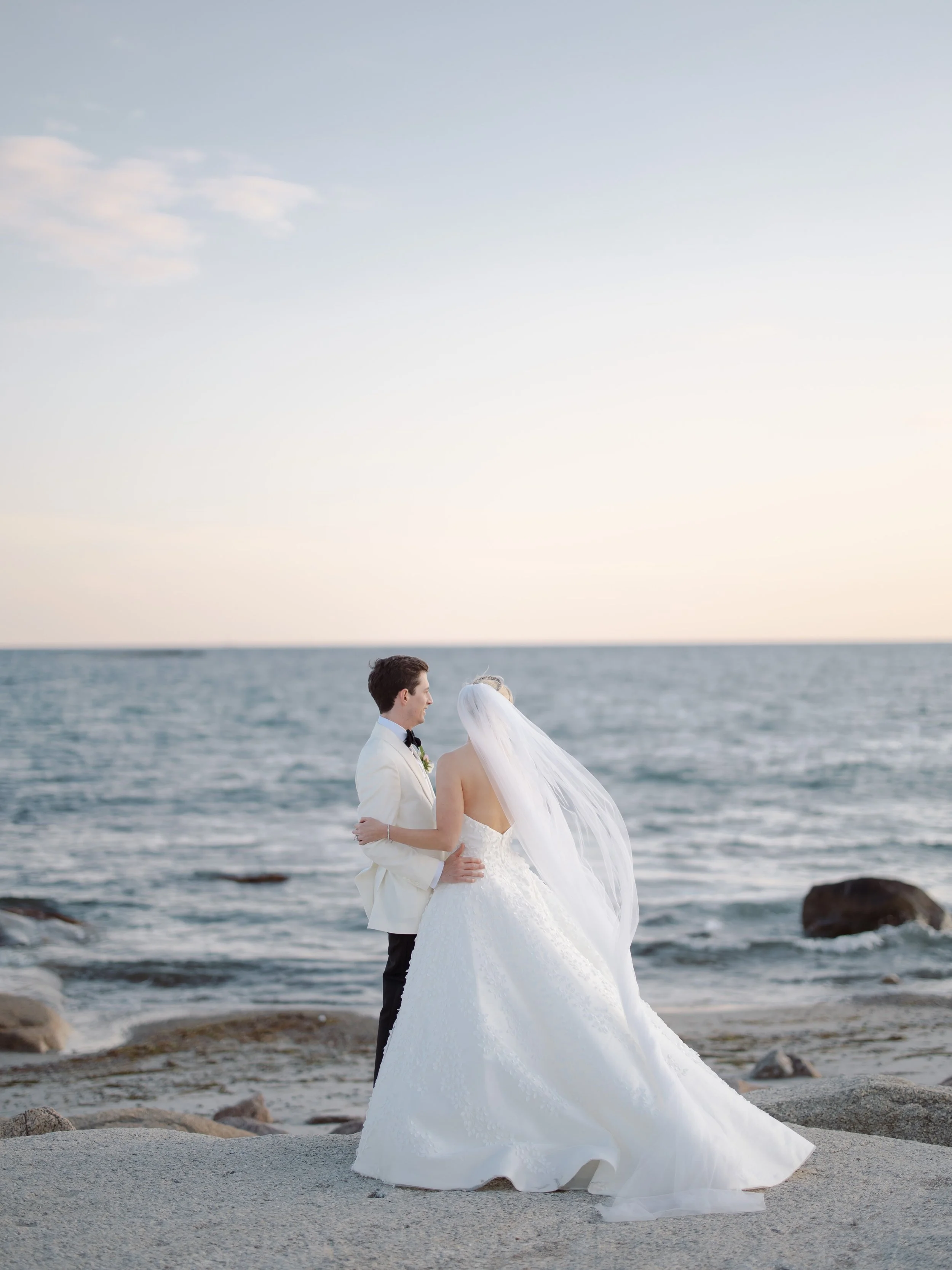 Photo of couple on wedding day looking out to the sea - New England wedding