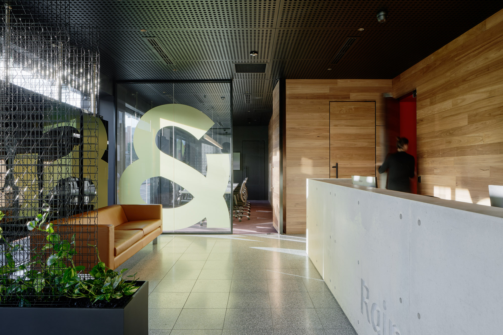 Raine & Horne. Brunswick Flagship office fit-out for real estate agent Raine & Horne in Brunswick. The fit-out provides an open and transparent reception with controlled sight lines to the meeting and board rooms. A timeless material palette conveys a sense of welcome to the front of house, whilst the back of house gives over to a more playful expression with coloured view finding panels and articulated ceilings to ameliorate the closed box.