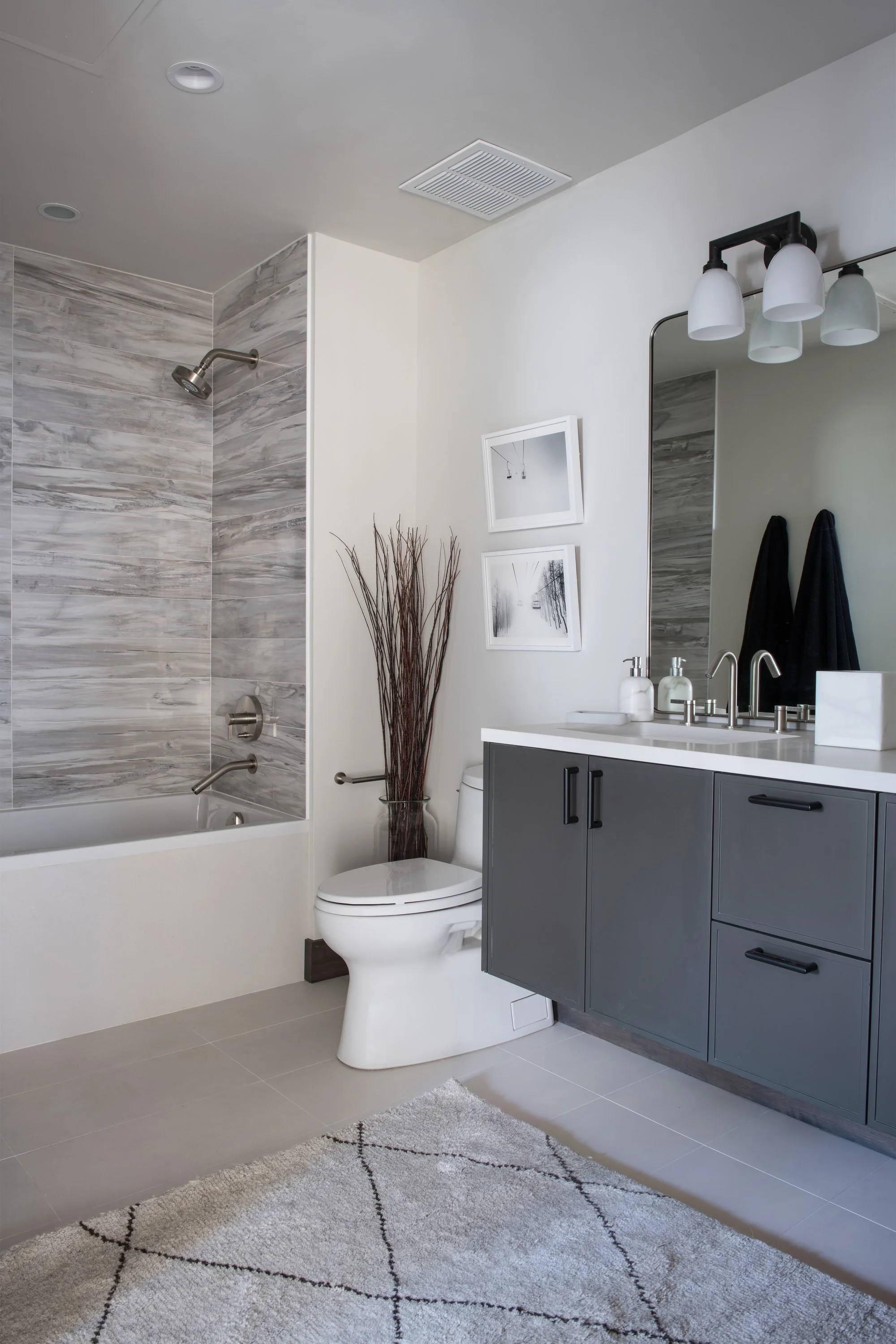 Modern bathroom with spacious cabinet and painting