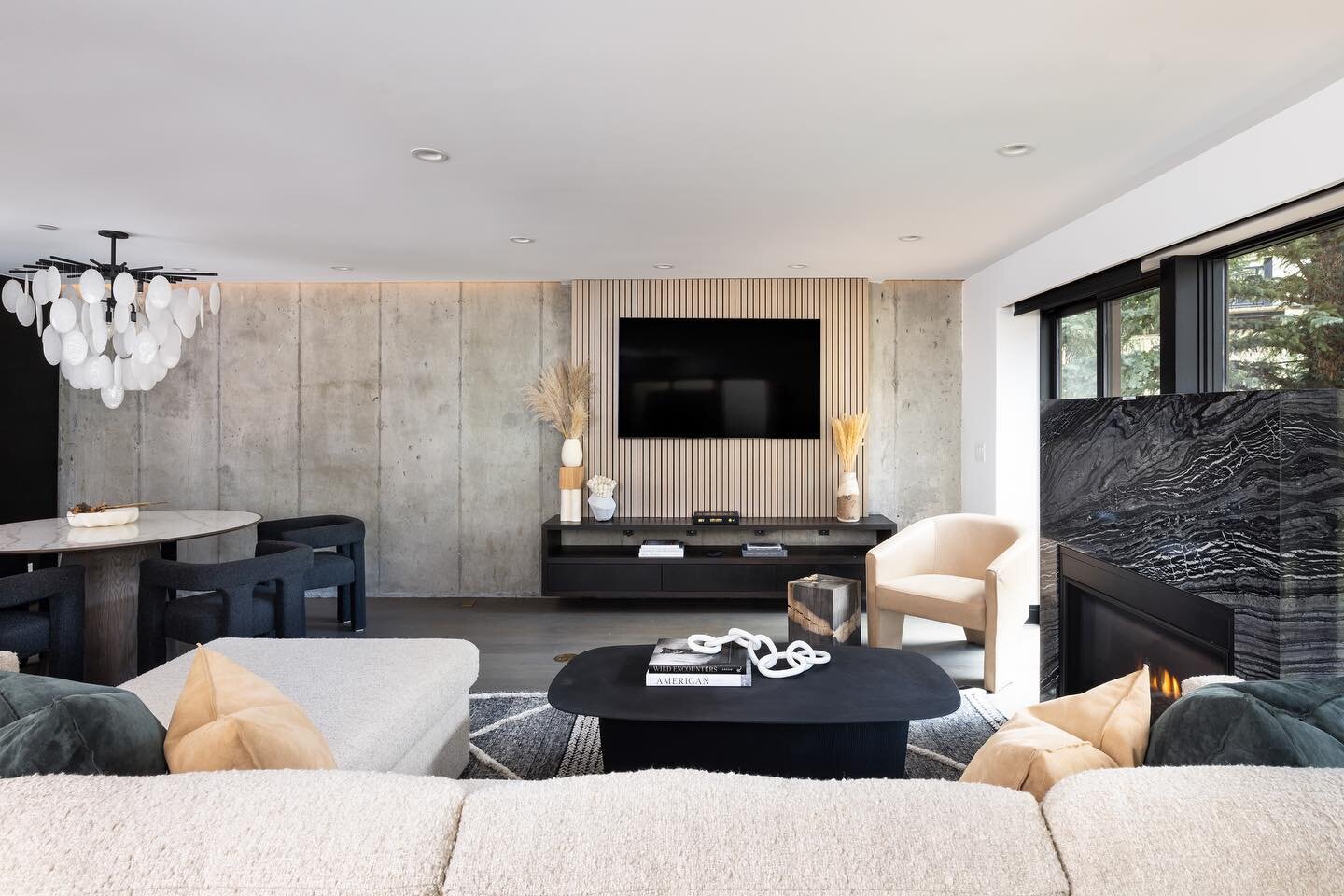 Fun Fact: See that amazing concrete wall back there behind the TV? At the beginning stages of the design our team found it within the structural plans, opened up the wall to make sure it was indeed real and then decided to expose it creating a featur