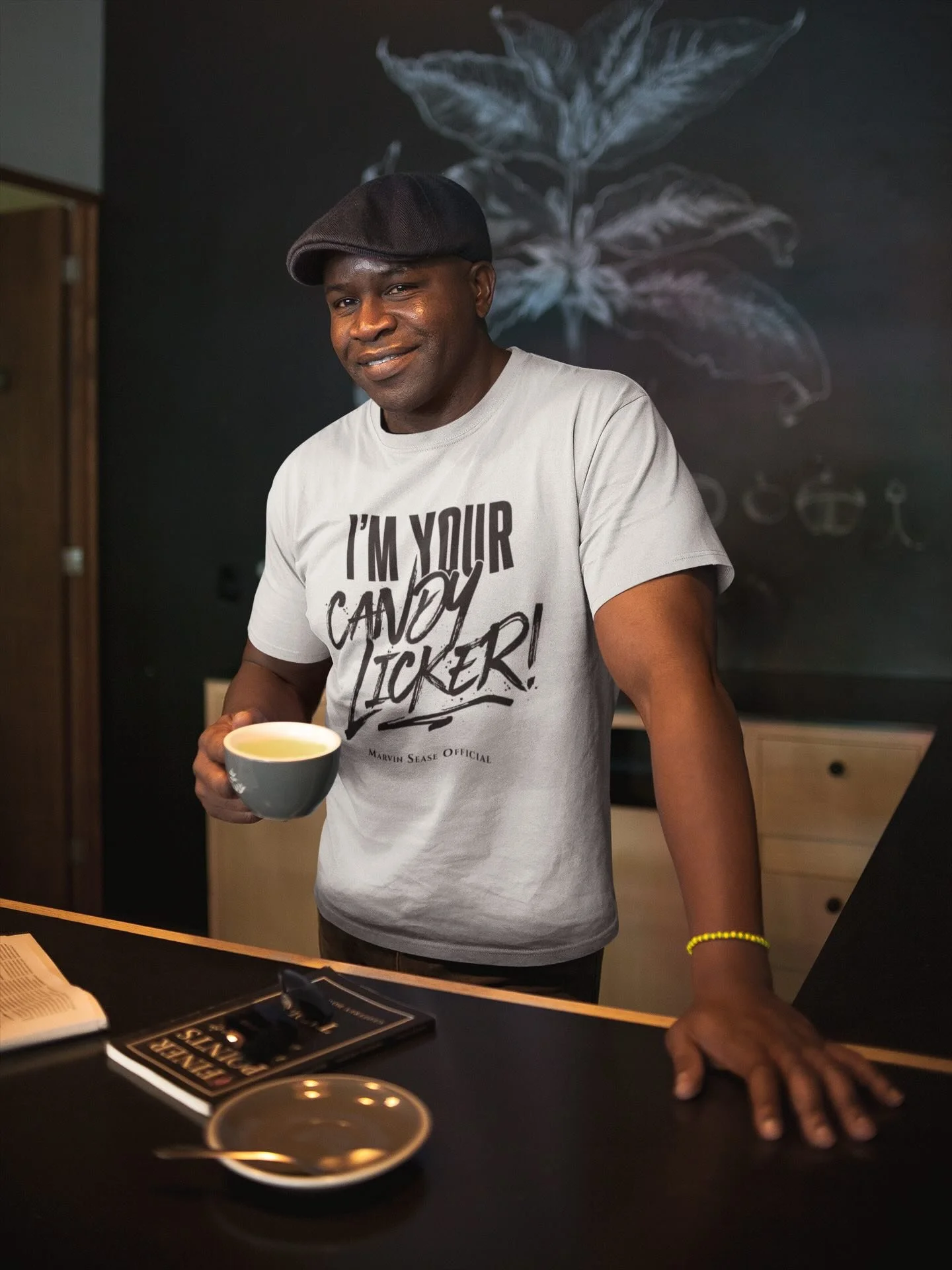 mockup-of-a-black-man-wearing-a-t-shirt-and-a-beret-having-a-coffee-a21423 (1).jpeg