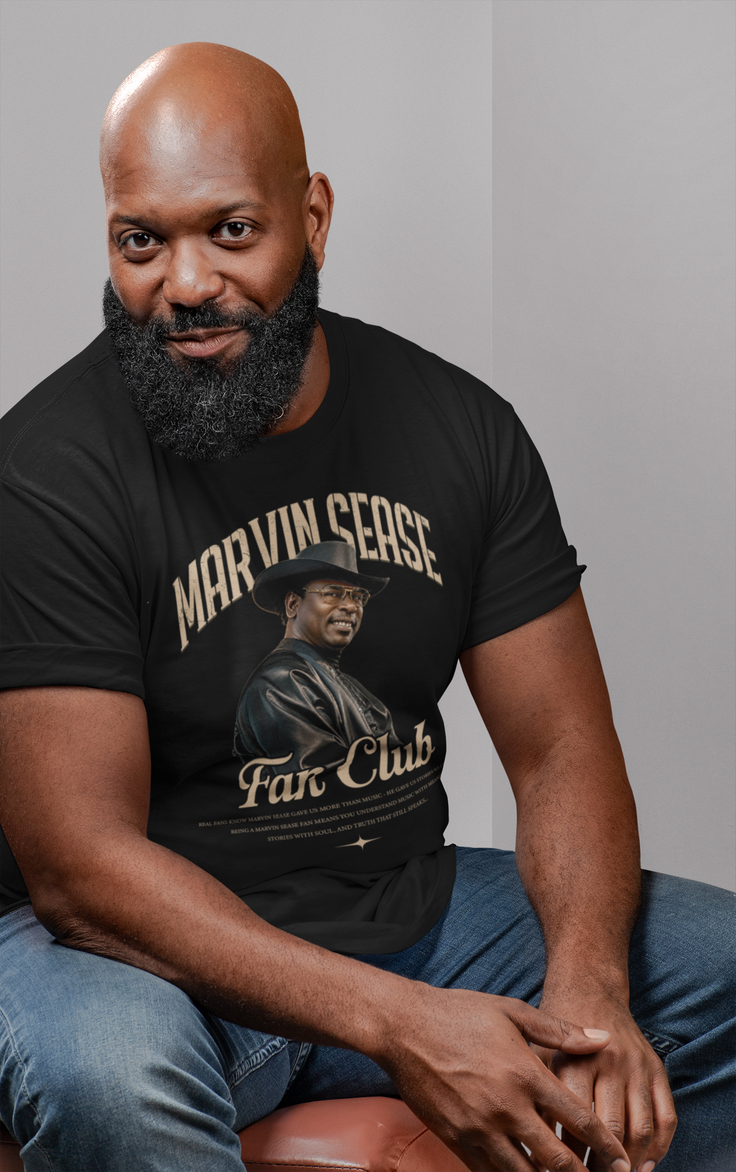 t-shirt-mockup-of-a-bald-bearded-man-sitting-on-a-chair-21526.png