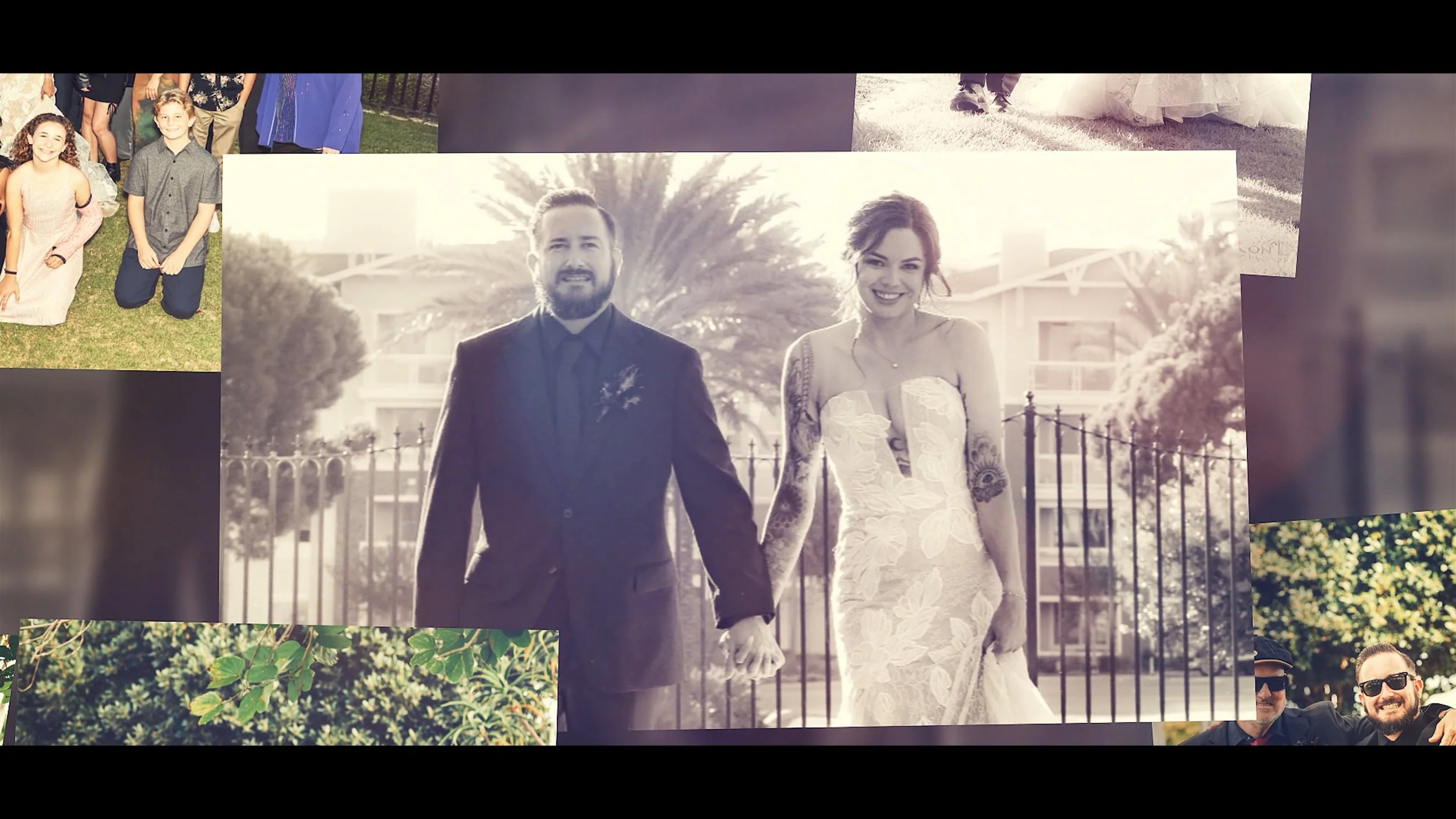 Black and white wedding photograph of a smiling couple holding hands, walking outdoors with a tree and building in the background.