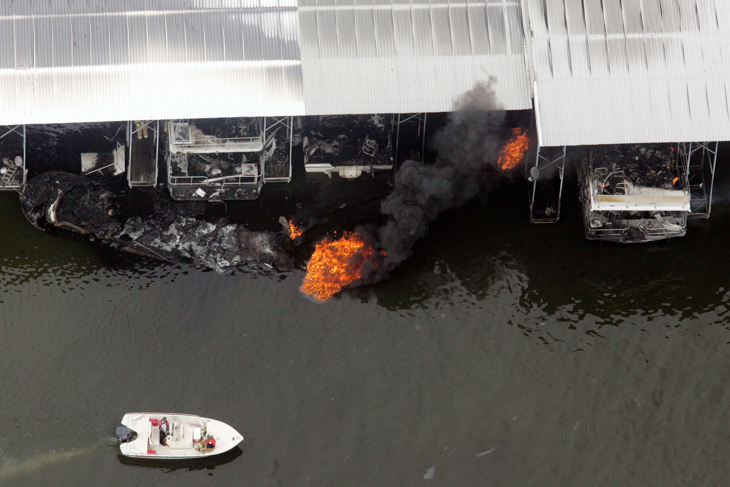  A boat motors by a fire that broke out in the marina March 8, 2006 in Hendersonville, Tenn. 