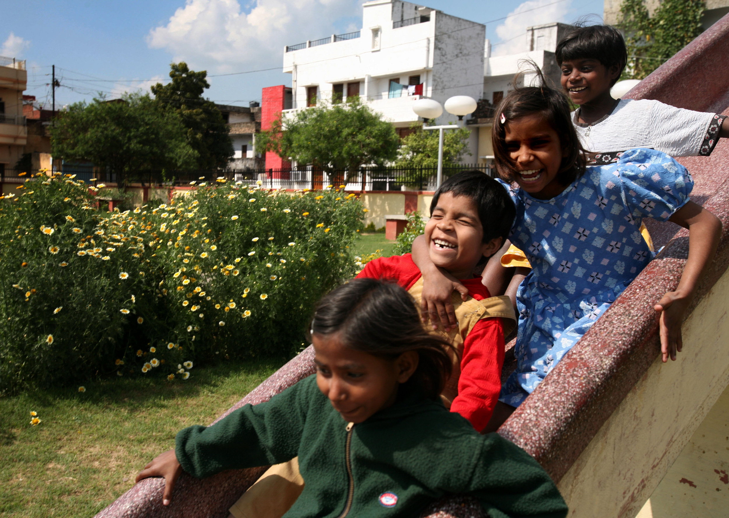  Kajal goes down the slide at the neighborhood park with the help of her children from the Snehlayam Shelter Home run by the Society of Underprivileged People Friday, March, 2, 2007 in Allahabad, India. 