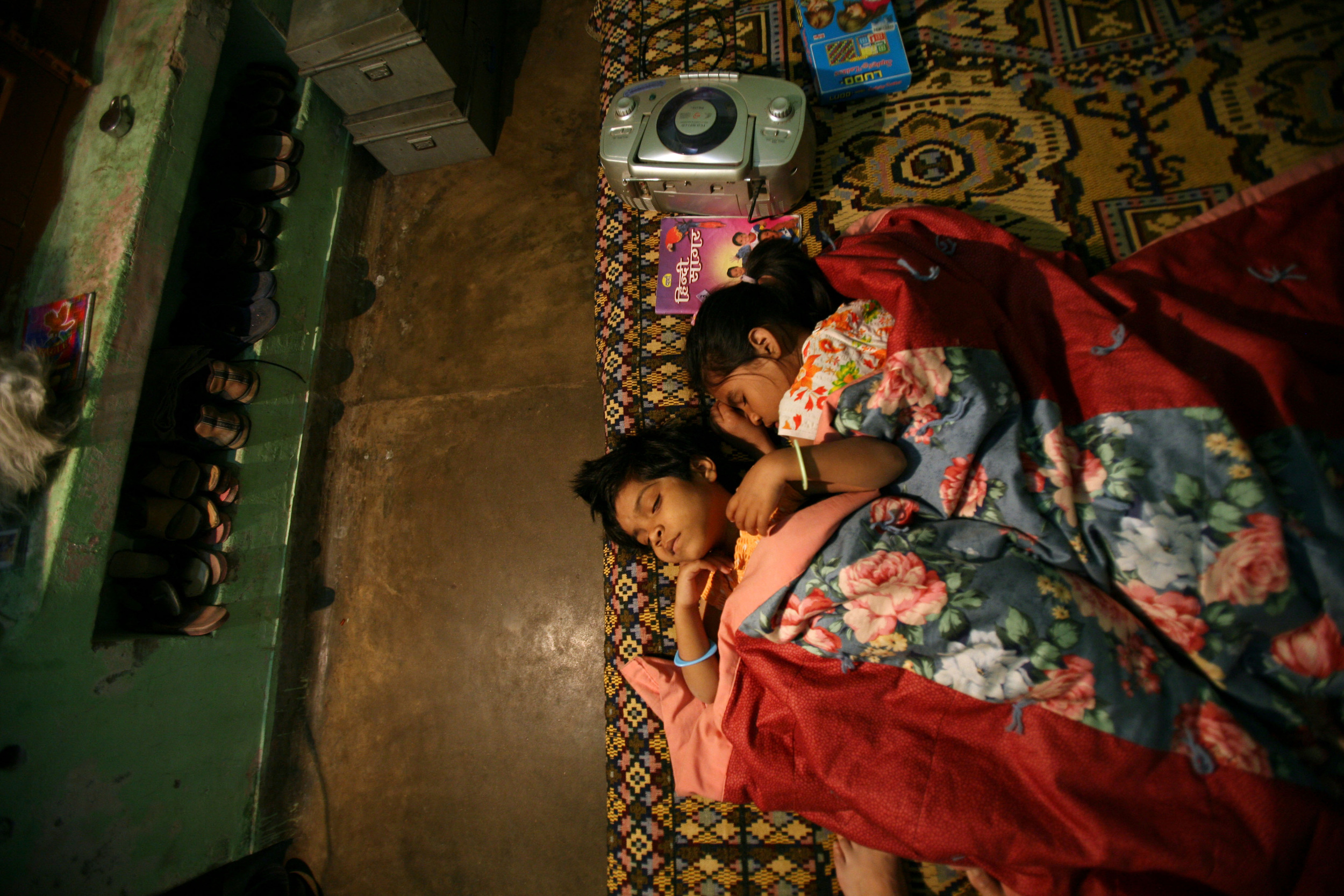  Kajal falls asleep curled next to her "sister" Madhu, right, at the Snehlayam Shelter Home Monday, March, 5, 2007 in Allahabad, India. 
