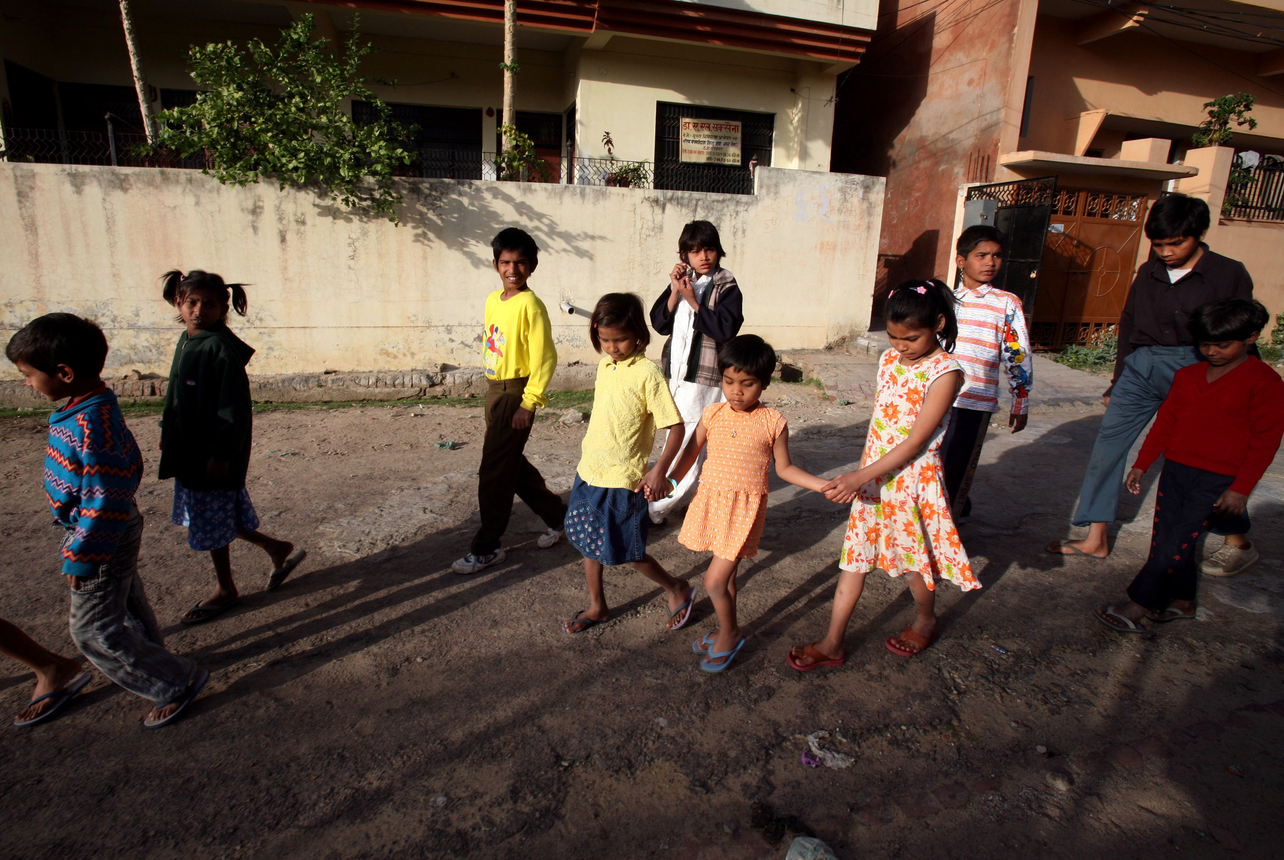  Kajal walks with the help of fellow children from the Snehlayam Shelter Home to the neighborhood park Monday, March, 5, 2007 in Allahabad, India. 