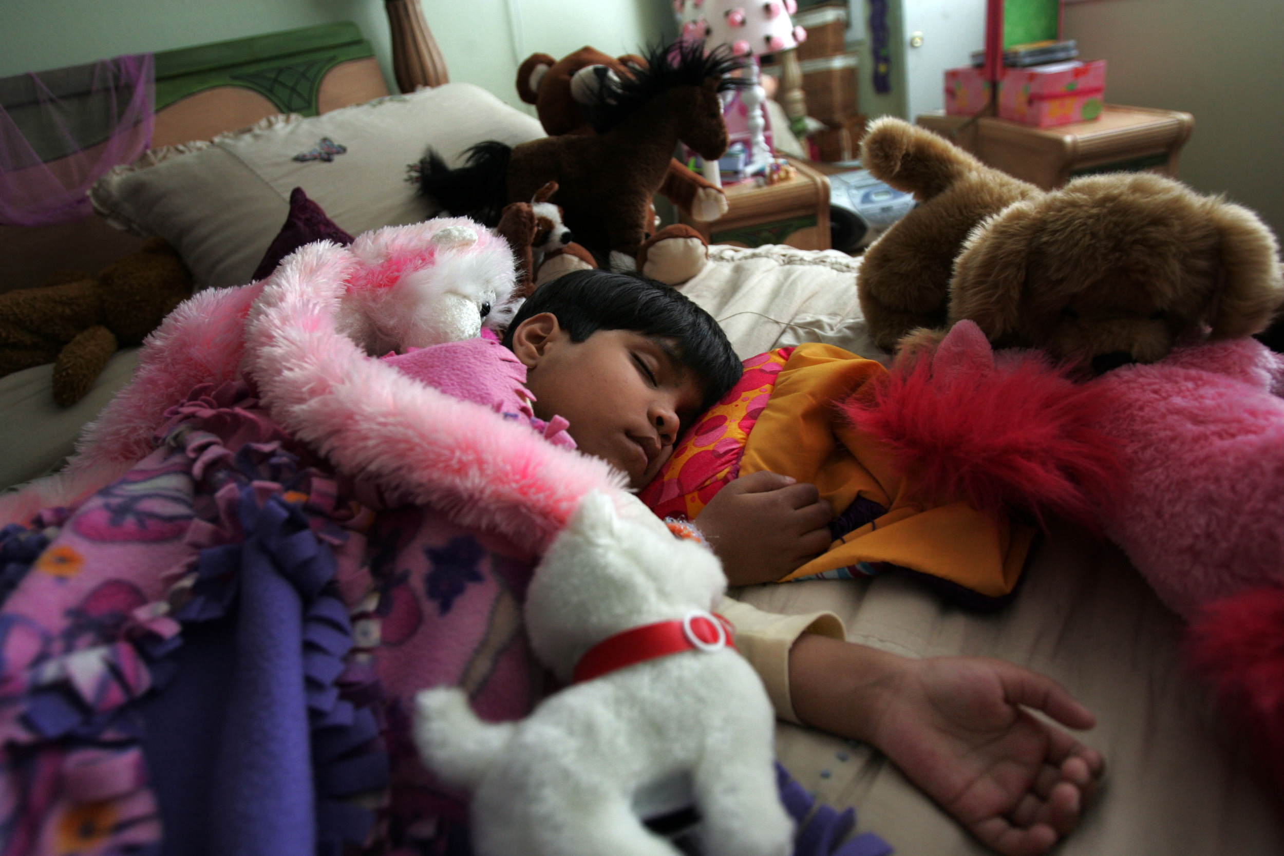  Kajal sleeps amongst a pile of stuffed animals at a host family’s house during her nap Tuesday, April 10, 2007 in Franklin, Tenn. On Kajal's arrival to the US she was showered with toys. 