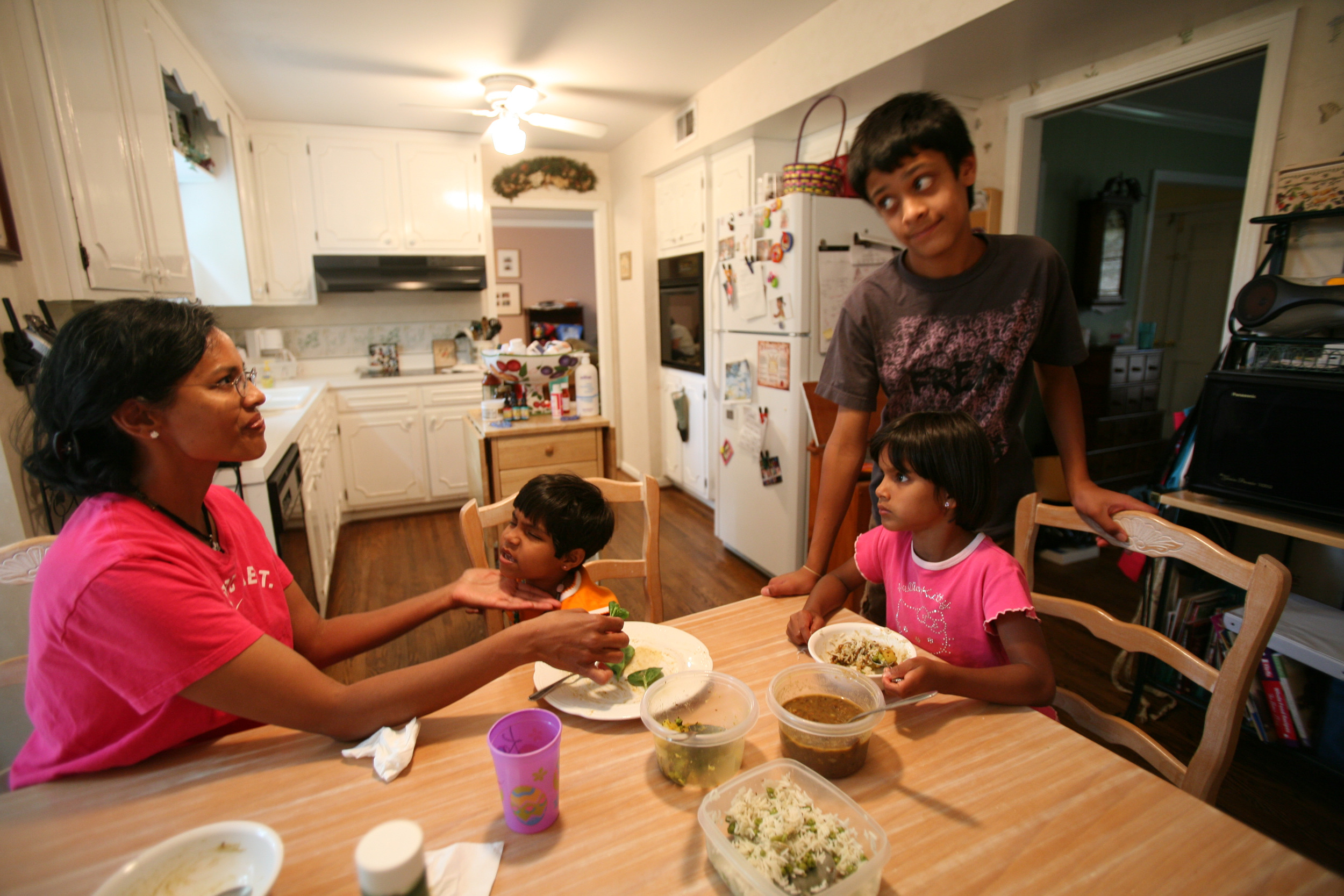  Karthi Masters, left, feeds Kajal at the dinner table with her children Davey, and Elijah in Franklin, Tenn., Wednesday, May 30, 2007. The Masters, who want to adopt Kajal, have already adopted Davey from India several years ago. 