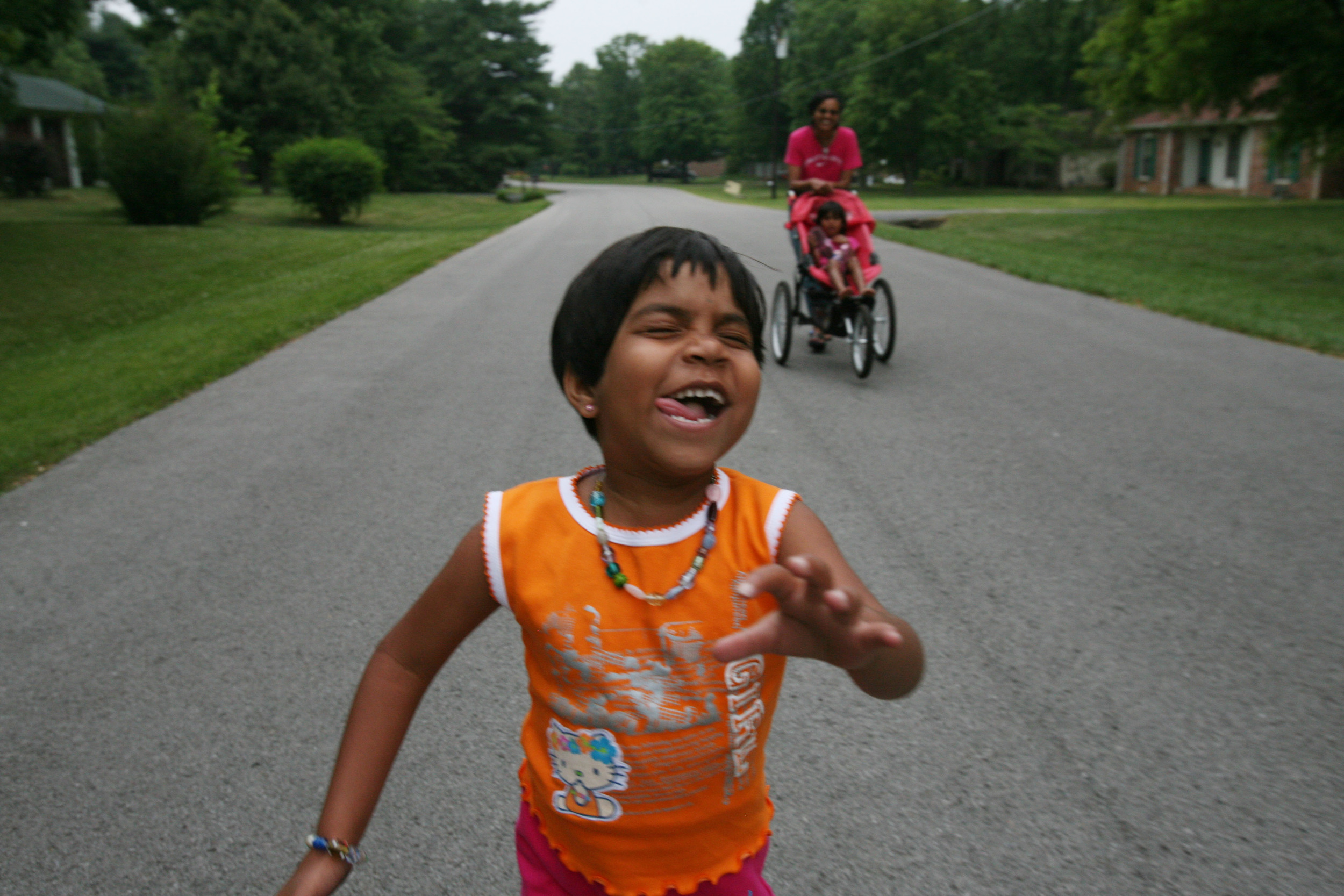  Kajal laughs as she runs down the middle of a quiet suburban street in Franklin, Tenn Wednesday, May 30, 2007. Despite the twists and turns of her difficult life, Kajal can be an exuberant and fearless child. 