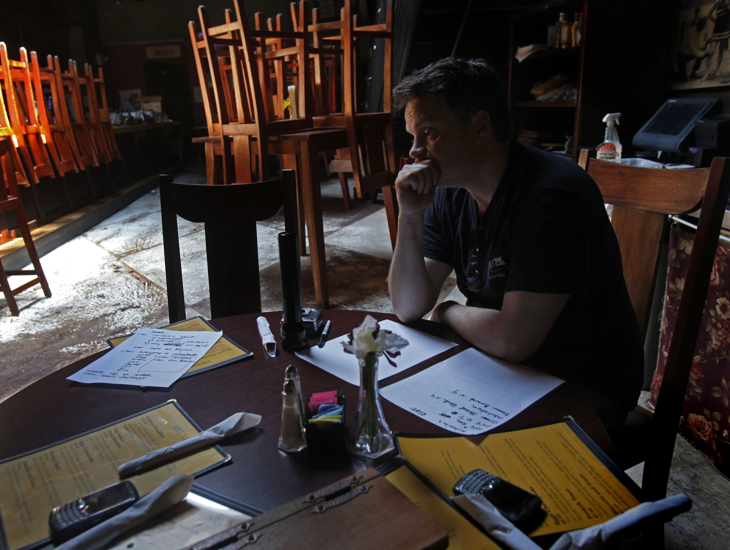  Shawn Courtney, co-owner of Past Perfect, sits in his restaurant and tries to figure out his losses after their downtown building flooded, May 6, 2010 in Nashville, Tenn. "We're hurting, " said Courtney, unsure if he can re-open. Past Perfect is his