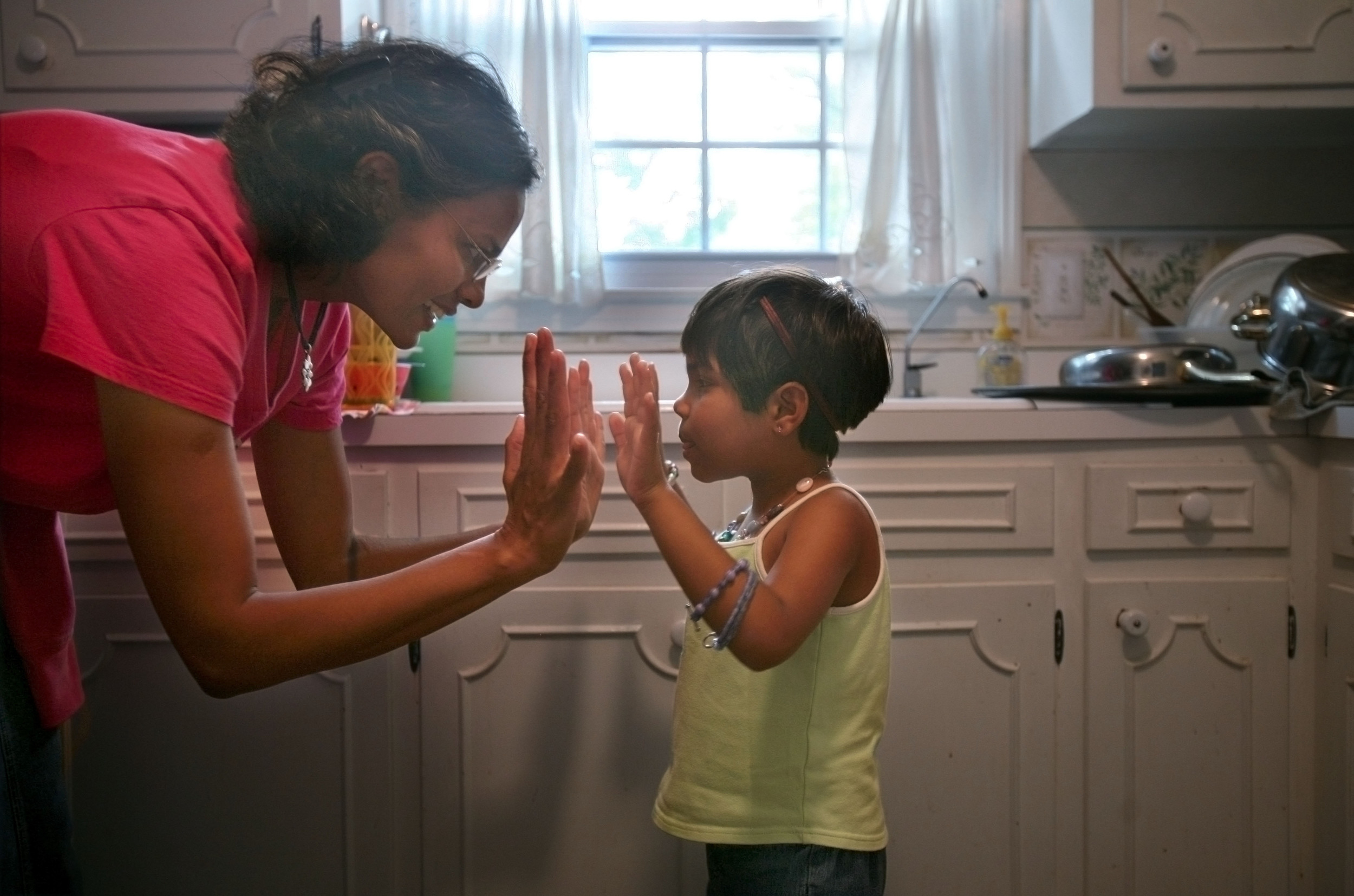  Karthi Masters gives Kajal a high five after she helped with the dishes Wednesday, May 30, 2007 in Franklin, Tenn. Kajal had developed a bond with Karthi and the Masters family. 